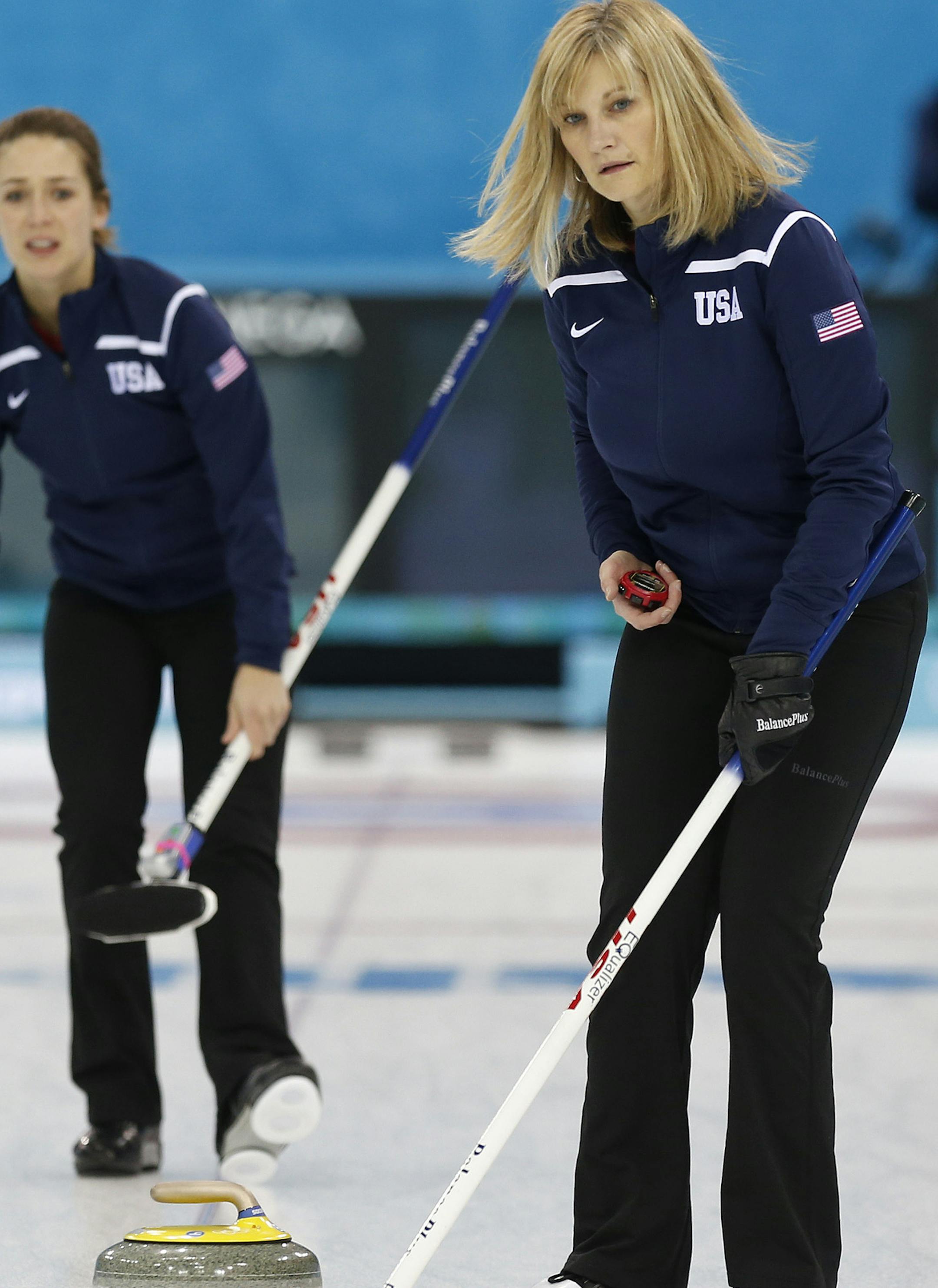 Team USA skip Erika Brown, right, uses a stopwatch to time the throw from teammate Jessica Schultz during the first day of curling training at the 2014 Winter Olympics, Saturday, Feb. 8, 2014, in Sochi, Russia. (AP Photo/Robert F. Bukaty)