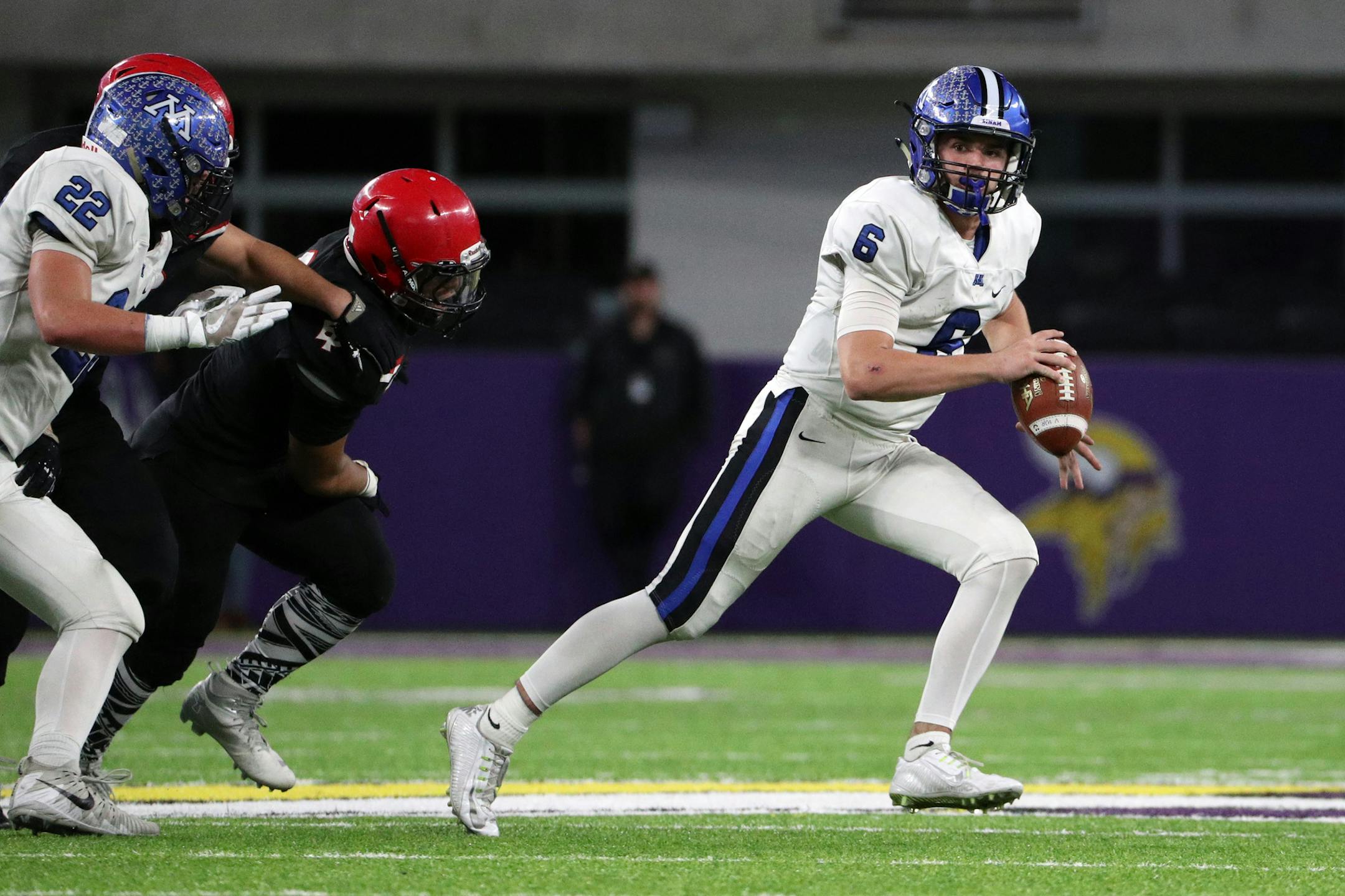 Minnetonka High School quarterback Aaron Syverson (6) scrambled under pressure to find an open receiver in the final minute of the first half. ] ANTHONY SOUFFLE ï anthony.souffle@startribune.com Game action from a Class 6A championship football game between Eden Prairie High School and Minnetonka High School Friday, Nov. 24, 2017 at U.S. Bank Stadium in Minneapolis.