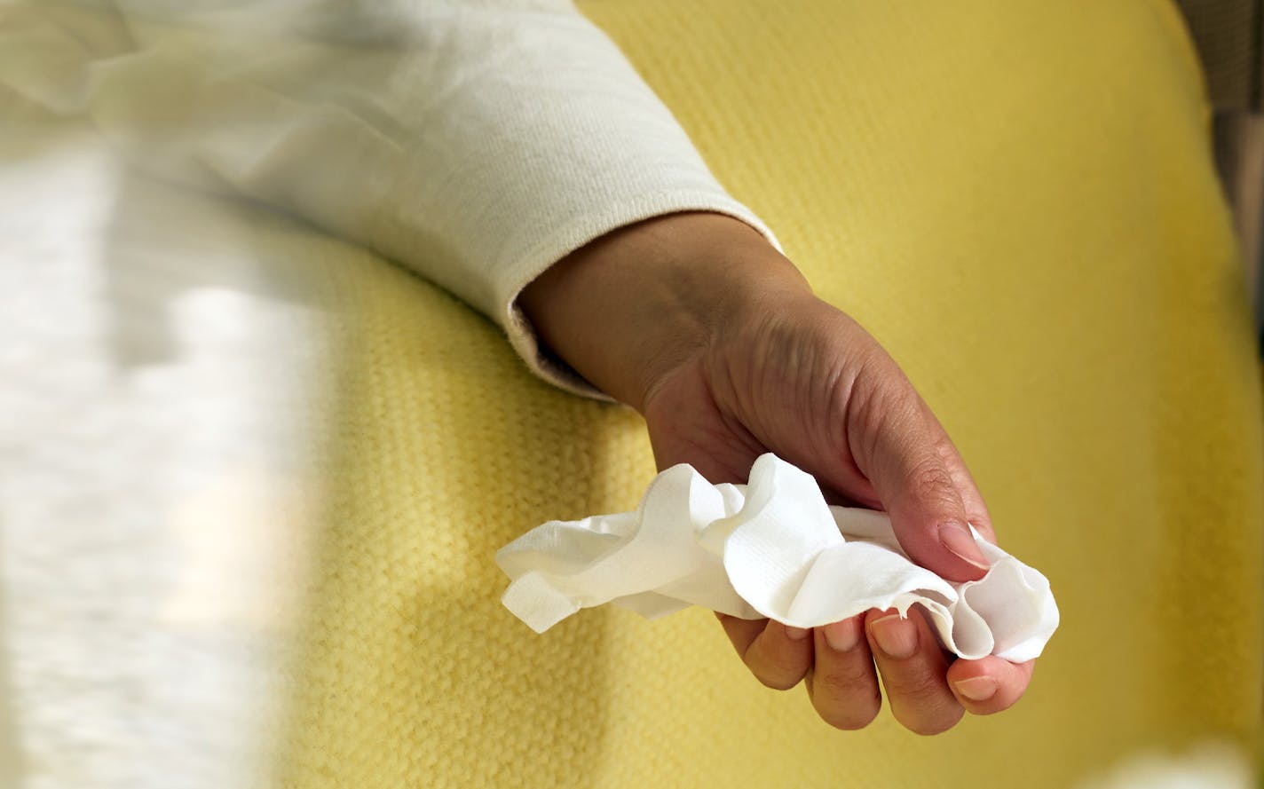 A woman holds a sheet of tissue paper in New York on March 11, 2023.