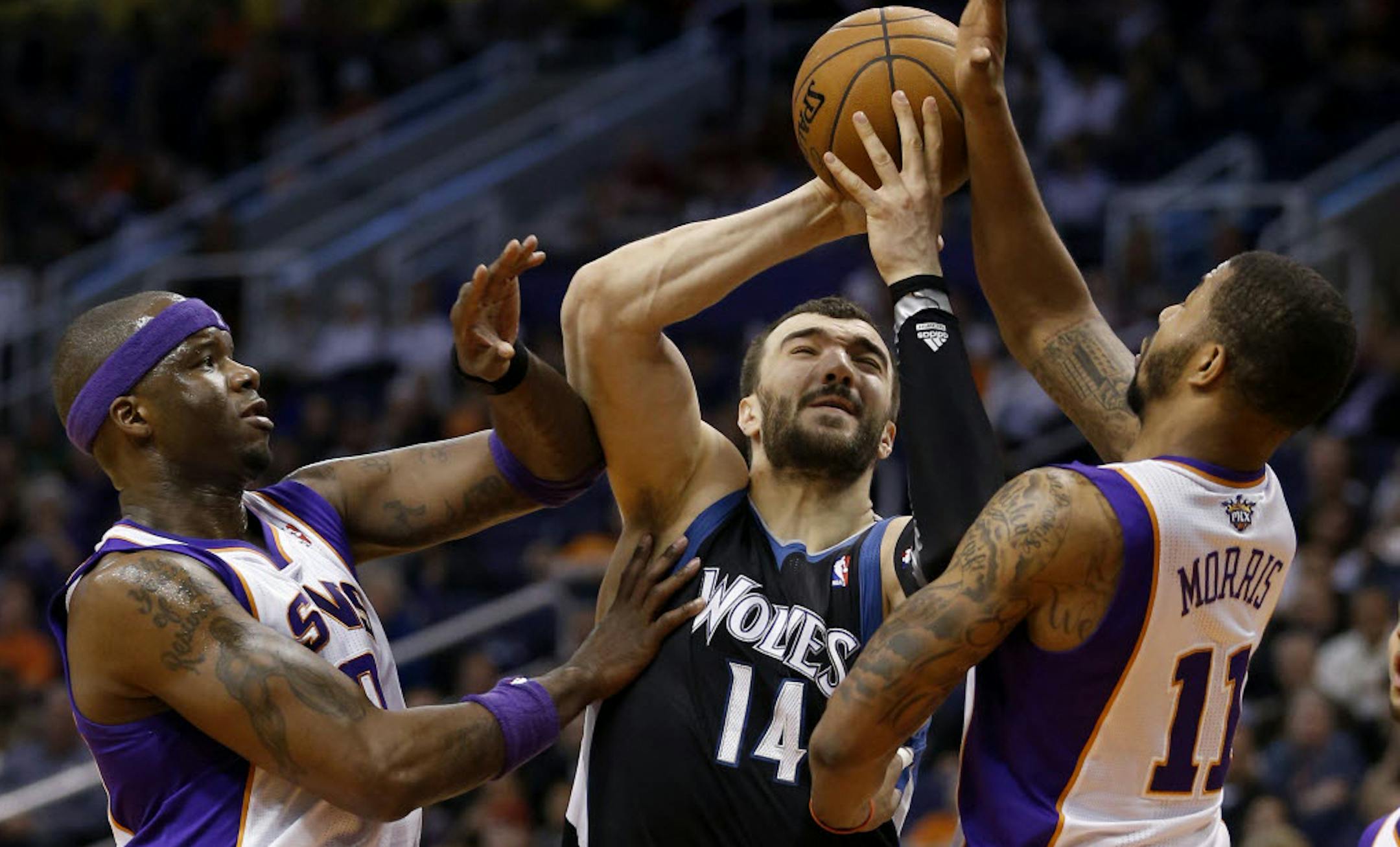 Wolves center Nikola Pekovic drove between the Suns' Markieff Morris (11) and Jermaine O'Neal.