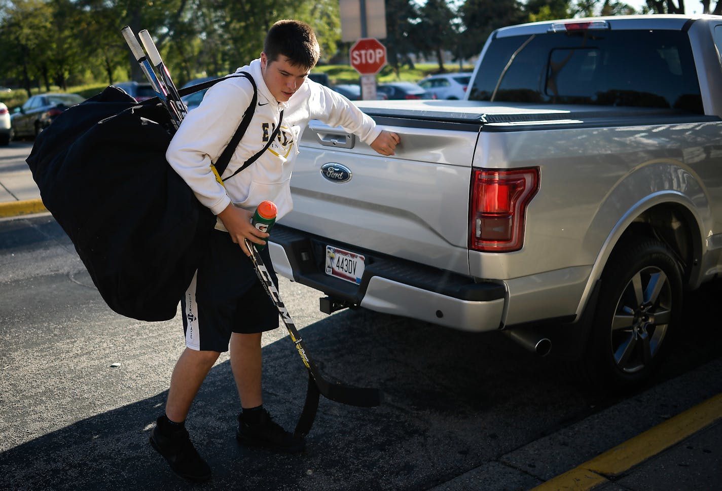 Totino-Grace freshman Luke Rooker grabbed his hockey gear from his father's truck as he walked into the Brooklyn Park Community Center ice arena for practice.