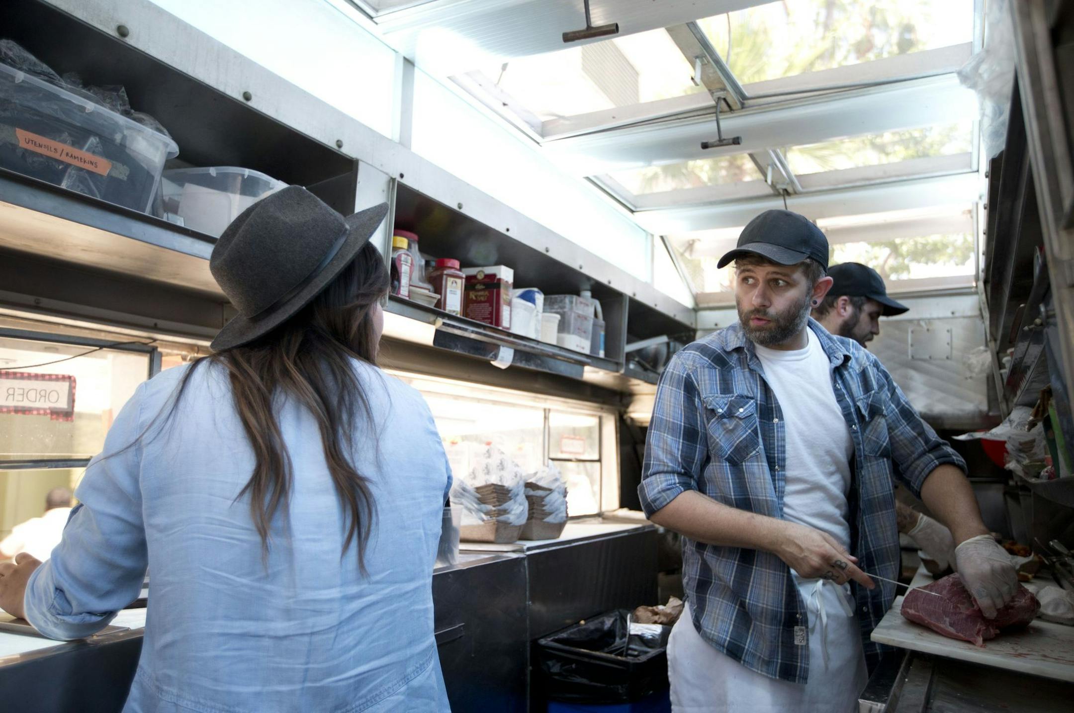 In this photo taken, July 10, 2015, food truck Peachesí Smokehouse & Southern Kitchen owners Ryan Lamon, right, and wife Diana chat while getting ready for business in Burbank, Calif. The health care law, minimum wage increases and paid sick leave laws in some states and cities are increasing costs for business owners like the Lamons (AP Photo/Jae C. Hong) ORG XMIT: NYBZ402