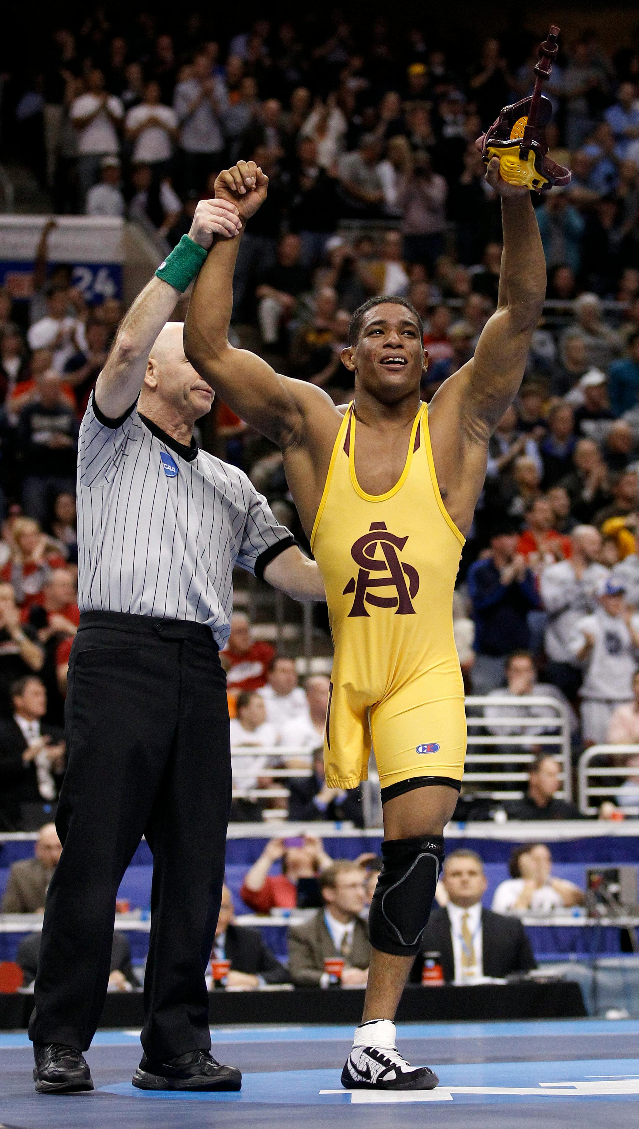 Arizona State's Anthony Robles, right, poses after beating Iowa's Matt McDonough in their 125-pound finals match, Saturday, March 19, 2011, at the NCAA Division I Wrestling Championships in Philadelphia. (AP Photo/Matt Slocum)