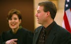 St. Paul, MN Tues 1/07/2003 Chief Judge Blatz ( left) jokes with Senator Dan Sparks after administering a ceremonial oath of office as he heads for th