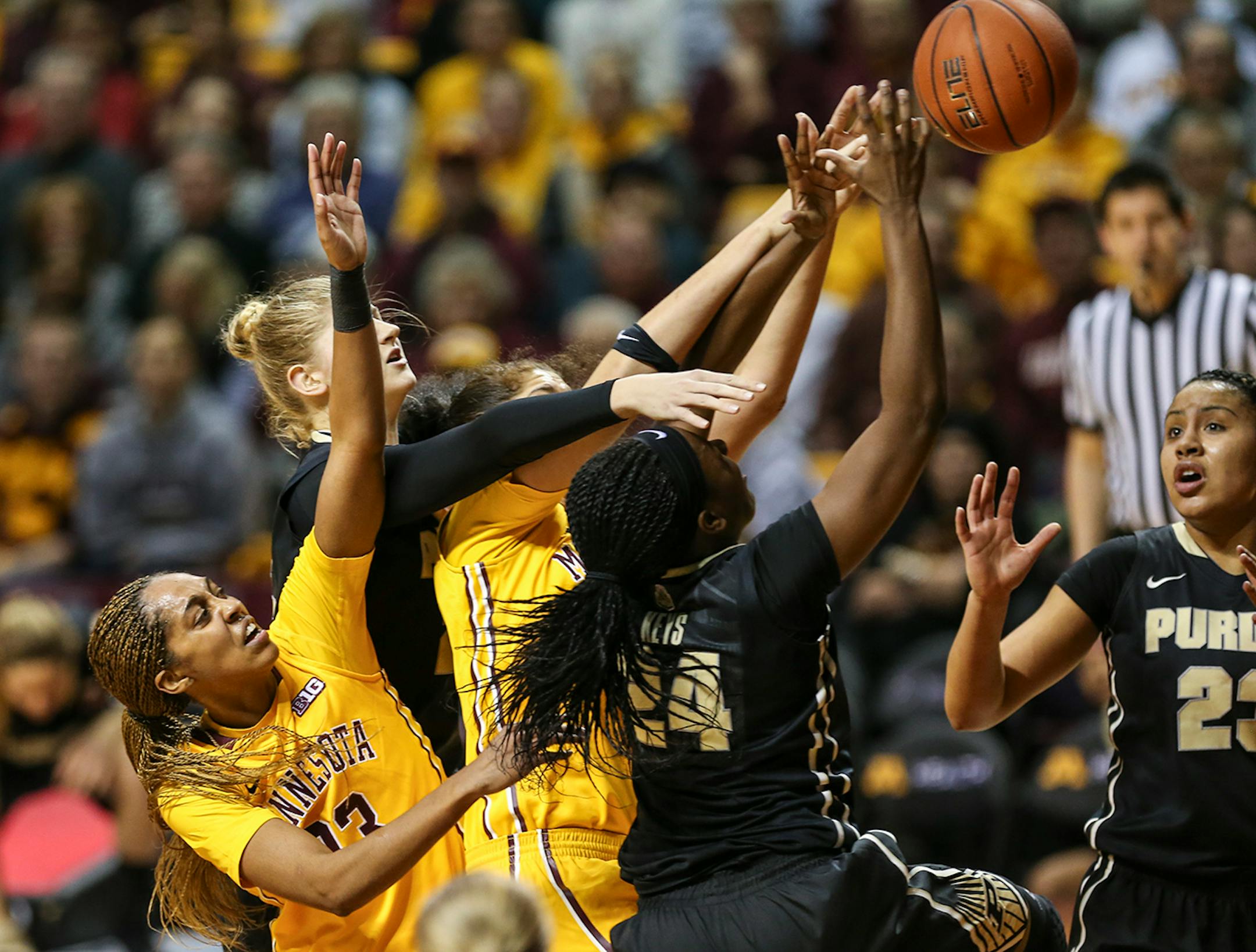 Gophers Shae Kelley (24) and Amanda Zahui B. (32) got tangled up with Purdue's Andreona Keys (24) and Bree Horrocks (22) in a struggle for the ball during the first half. ] RENEE JONES SCHNEIDER • reneejones@startribune.com Minnesota Gophers women's basketball verse. Purdue Boilermakers at Williams Arena at the University of Minnesota on Thursday, January 22, 2015 in Minneapolis, Minn.