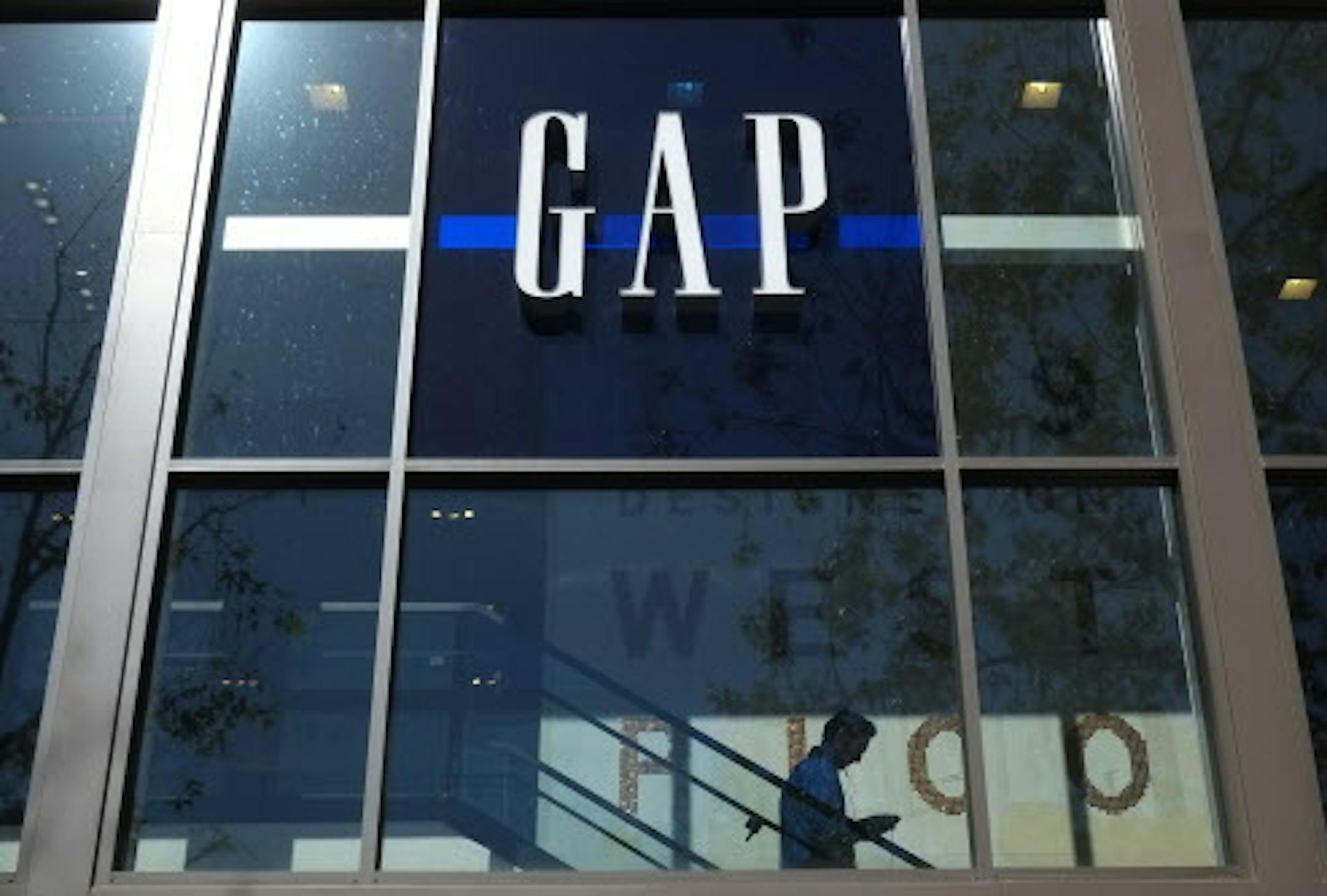 FILE - In this Tuesday, Feb. 26, 2013, file photo, a shopper walks down the steps at a Gap store in Los Angeles. Gap Inc. has announced plans to produce clothing in Myanmar, the first American retailer to enter the market since the country began its transition to democracy three years ago. (AP Photo/Jae C. Hong, Pool)
