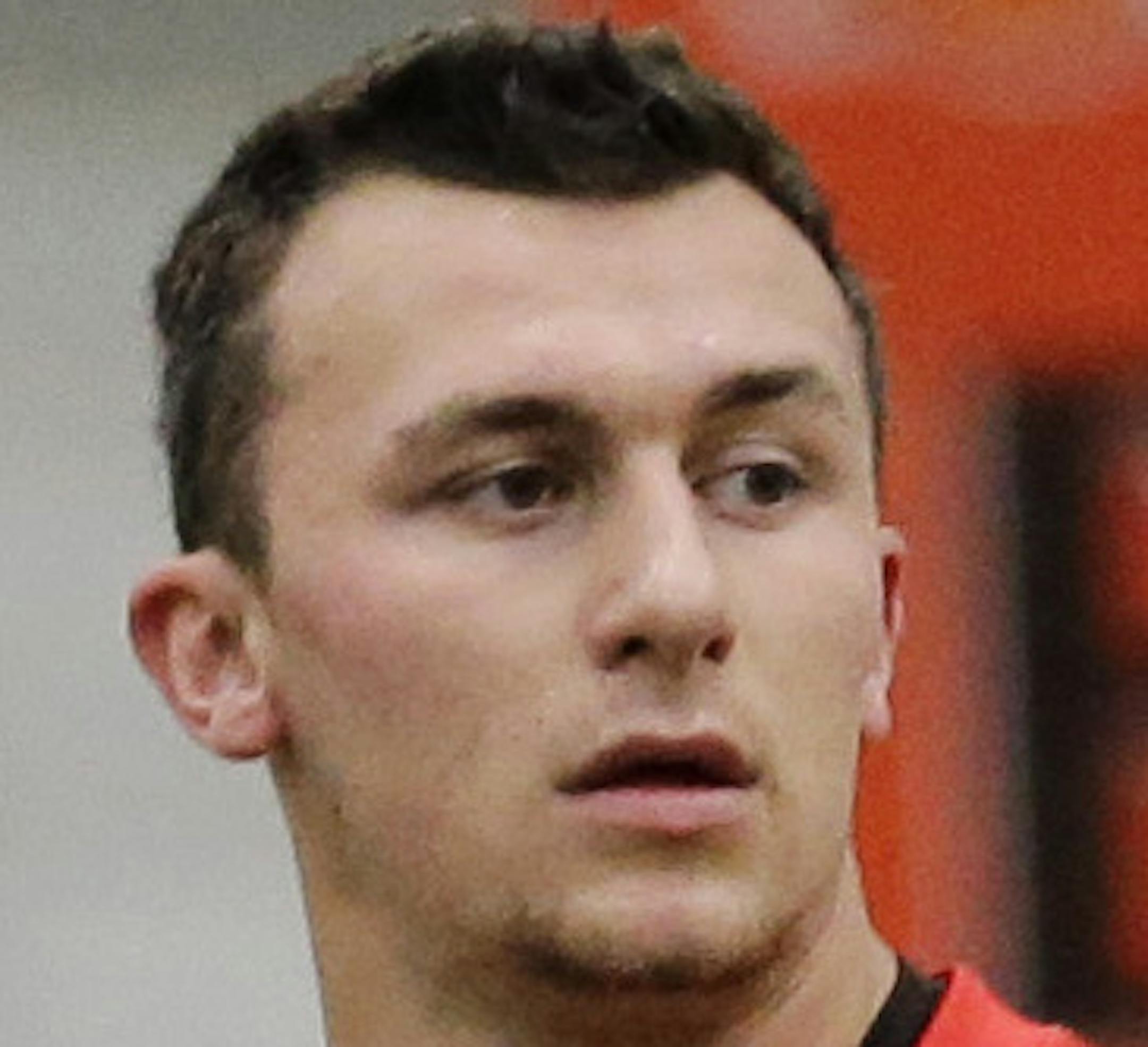Cleveland Browns quarterback Johnny Manziel (2) stretches before a rookie minicamp practice at the NFL football team's facility in Berea, Ohio Saturday, May 17, 2014. (AP Photo/Mark Duncan)