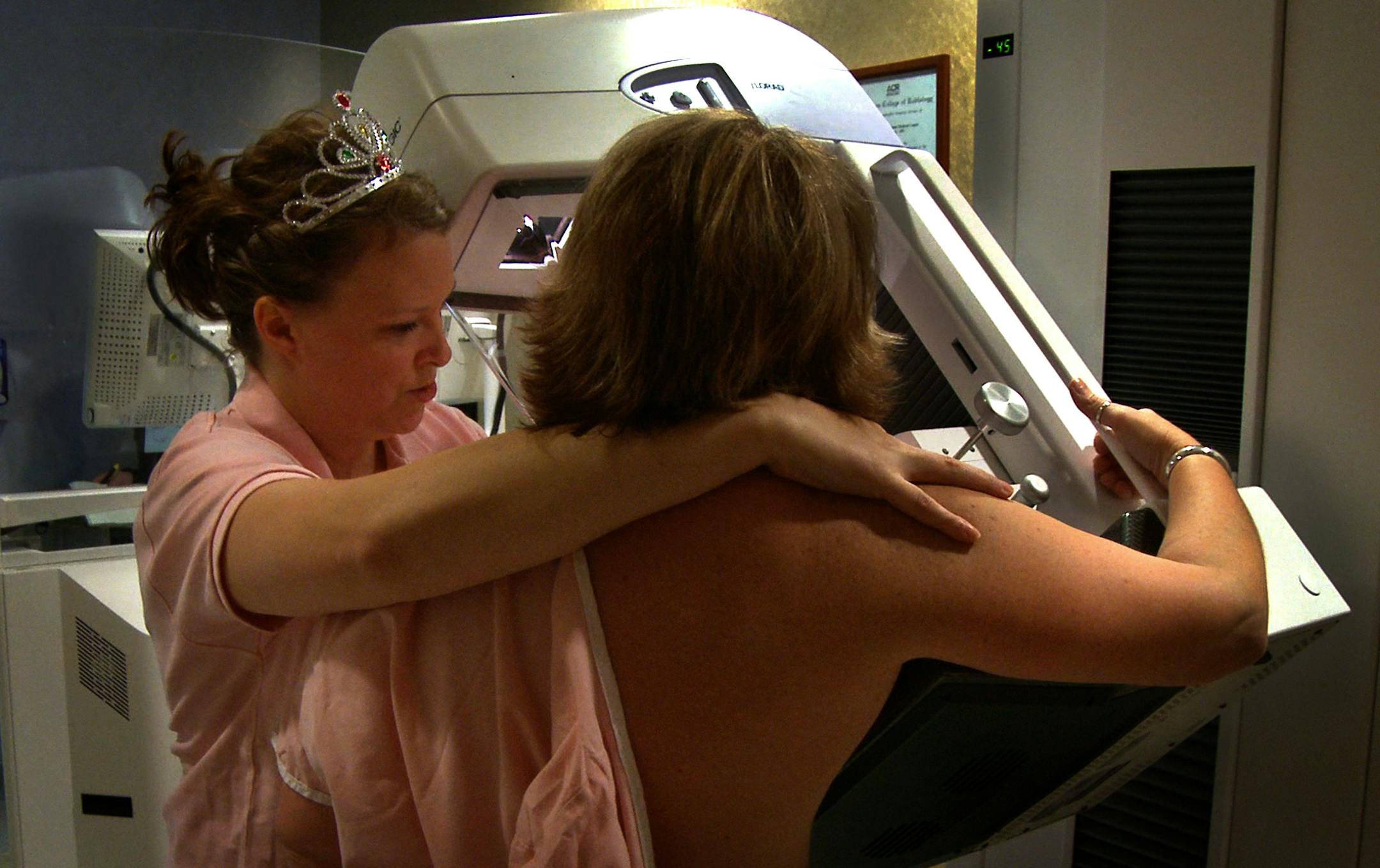Jennifer Kroska, mammographer, postions Sharon White, right, for her mammogram.