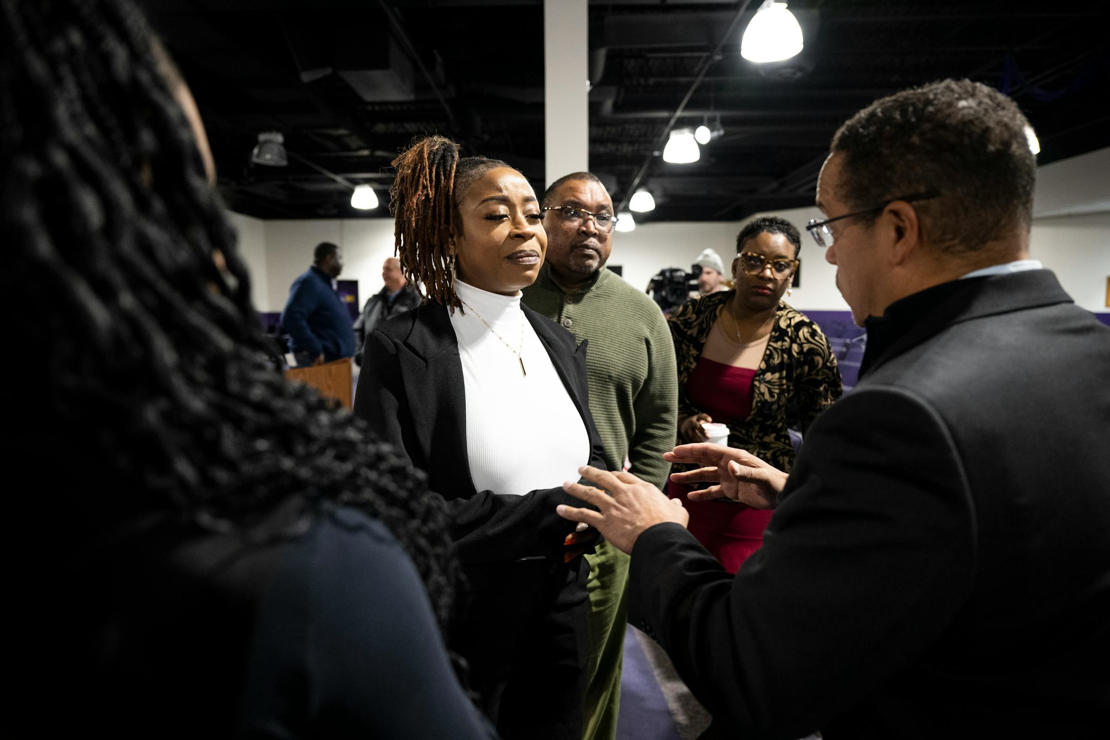 Minnesota Attorney General Keith Ellison, right, speaks with family members of Zaria McKeever, including her sister Tiffynnie Epps and stepfather Paul Greer Wednesday at Shiloh Temple in Minneapolis.