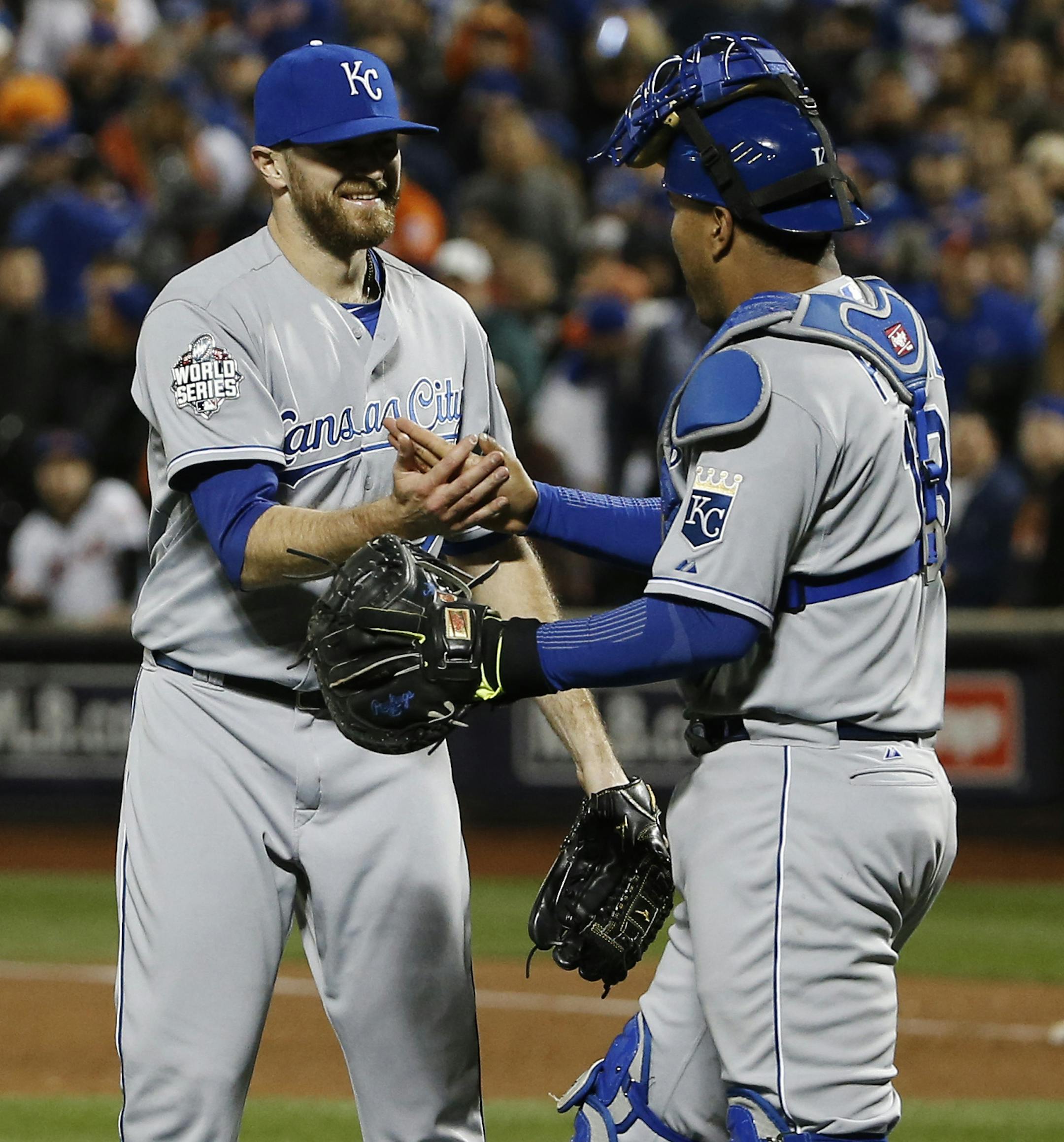 Kansas City Royals pitcher Wade Davis is congratulated by catcher Salvador Perez after winning Game 4 of the Major League Baseball World Series Saturday, Oct. 31, 2015, in New York. The Royals won 5-3 to take a 3-1lead in the series. (AP Photo/Matt Slocum)
