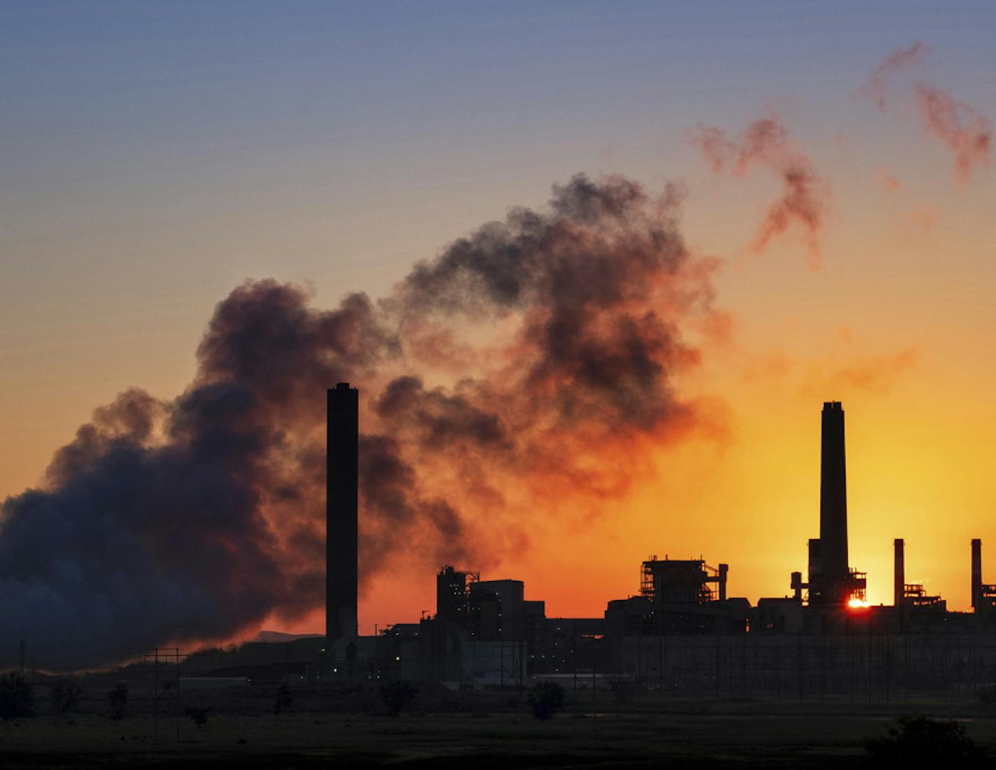 In this July 27, 2018 photo, the Dave Johnson coal-fired power plant is silhouetted against the morning sun in Glenrock, Wyo. The Trump administration on Tuesday proposed a major rollback of Obama-era regulations on coal-fired power plants, striking at one of the former administration&#x2019;s legacy programs to rein in climate-changing fossil-fuel emissions. (AP Photo/J. David Ake) ORG XMIT: WYDA101