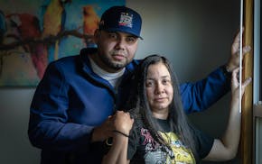 Luis Juárez, left, and his wife Mayrink Cumana talk about Juarez’s alleged torture by the Venezuelan military shortly before he escaped to Minnesot