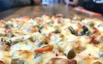 RED'S SAVOY PIZZA
Minnesota-style &#x2014; according to Red's Savoy &#x2014; is a thin-crust, square-cut pizza with loads of cheese and toppings and a