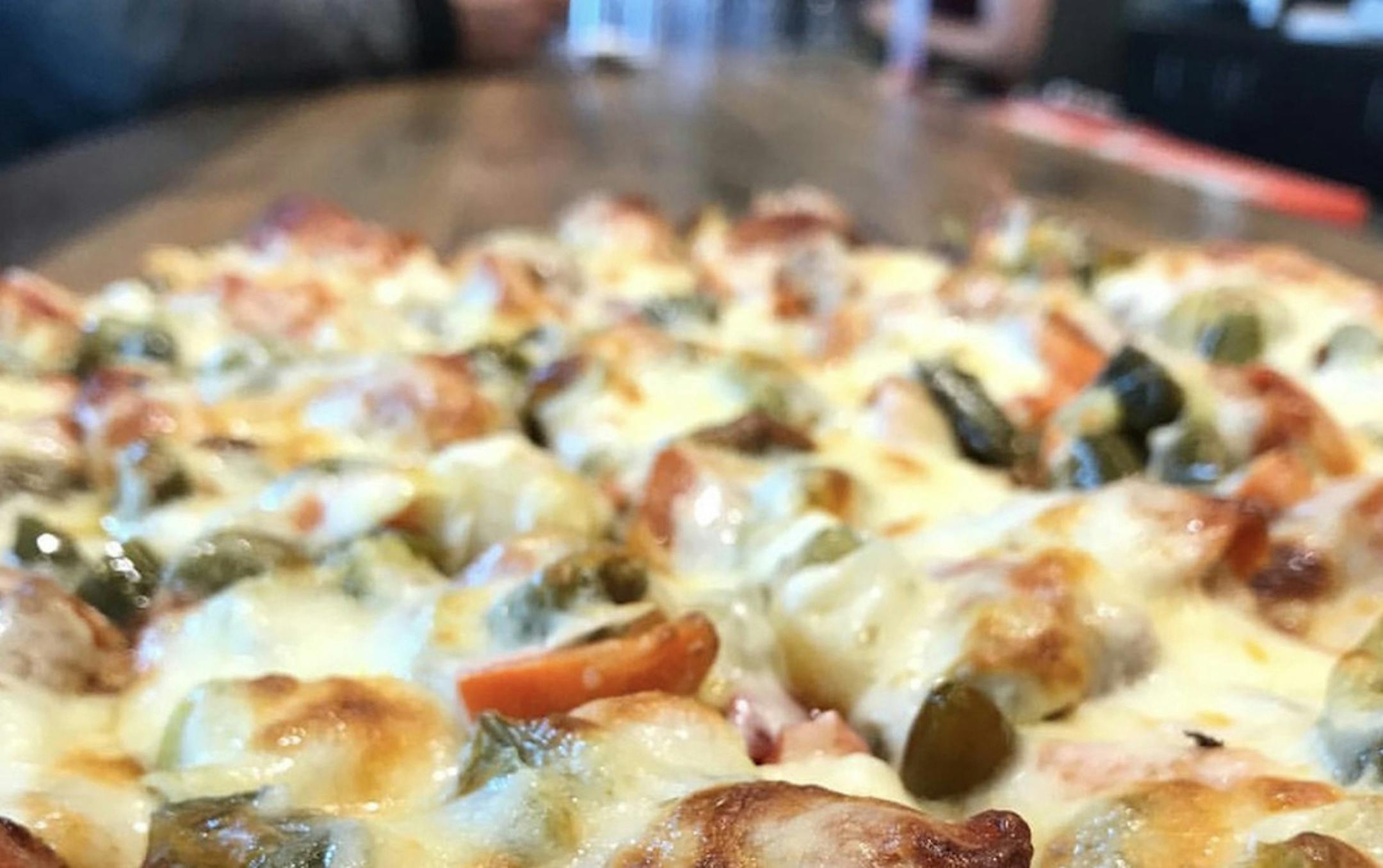 RED'S SAVOY PIZZA
Minnesota-style — according to Red's Savoy — is a thin-crust, square-cut pizza with loads of cheese and toppings and a signature spicy "passive aggressive" sauce.