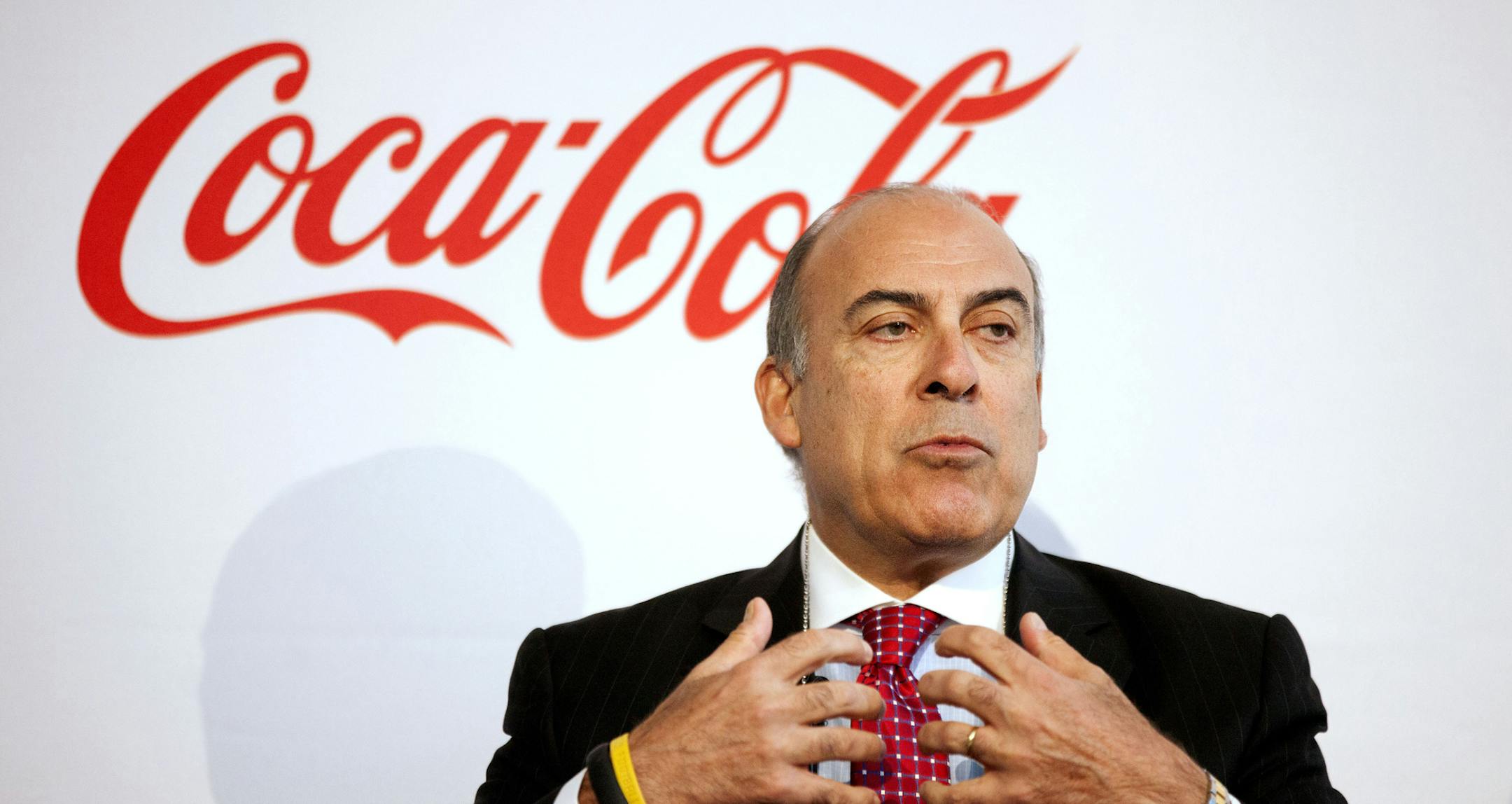 Coca-Cola CEO Muhtar Kent, center, speaks at an event where the the Coca-Cola Foundation pledged $3.8 million to support statewide initiatives aimed at boosting fitness and health, Wednesday, May 8, 2013, in Atlanta. The funds will be directed toward programs including Georgia SHAPE and Walk Georgia. (AP Photo/David Goldman) ORG XMIT: MIN2013052416492467