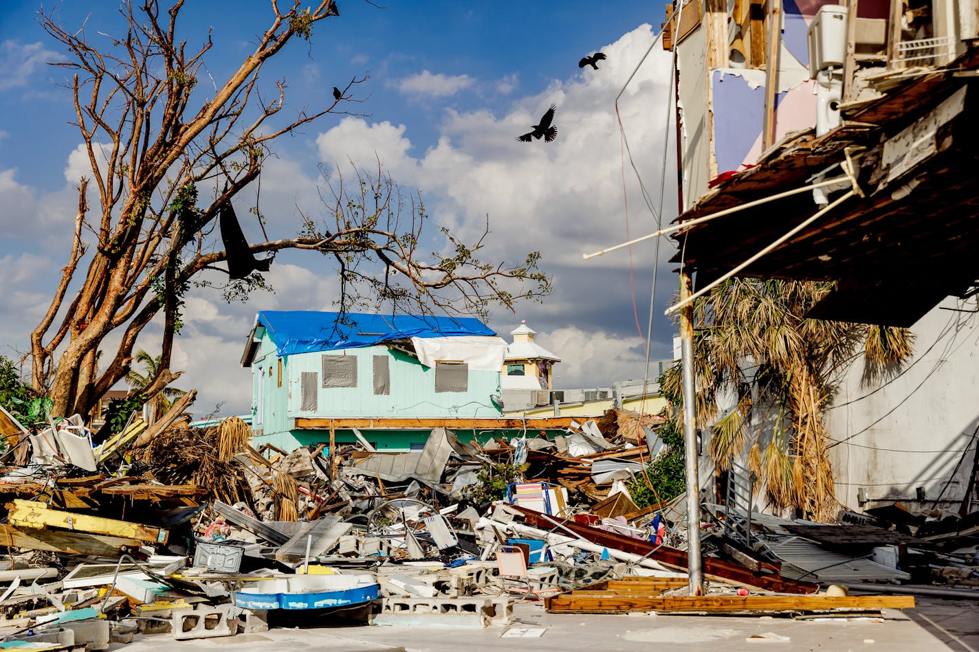 Shops and restaurants demolished by Hurricane Ian in Fort Myers Beach, Fla., Feb. 9, 2023. Communities like Fort Myers Beach, Sanibel and Captiva, devastated by the storm, are struggling to rebuild the hotel rooms, restaurants and rental units that keep their economy alive. (Scott McIntyre/The New York Times)