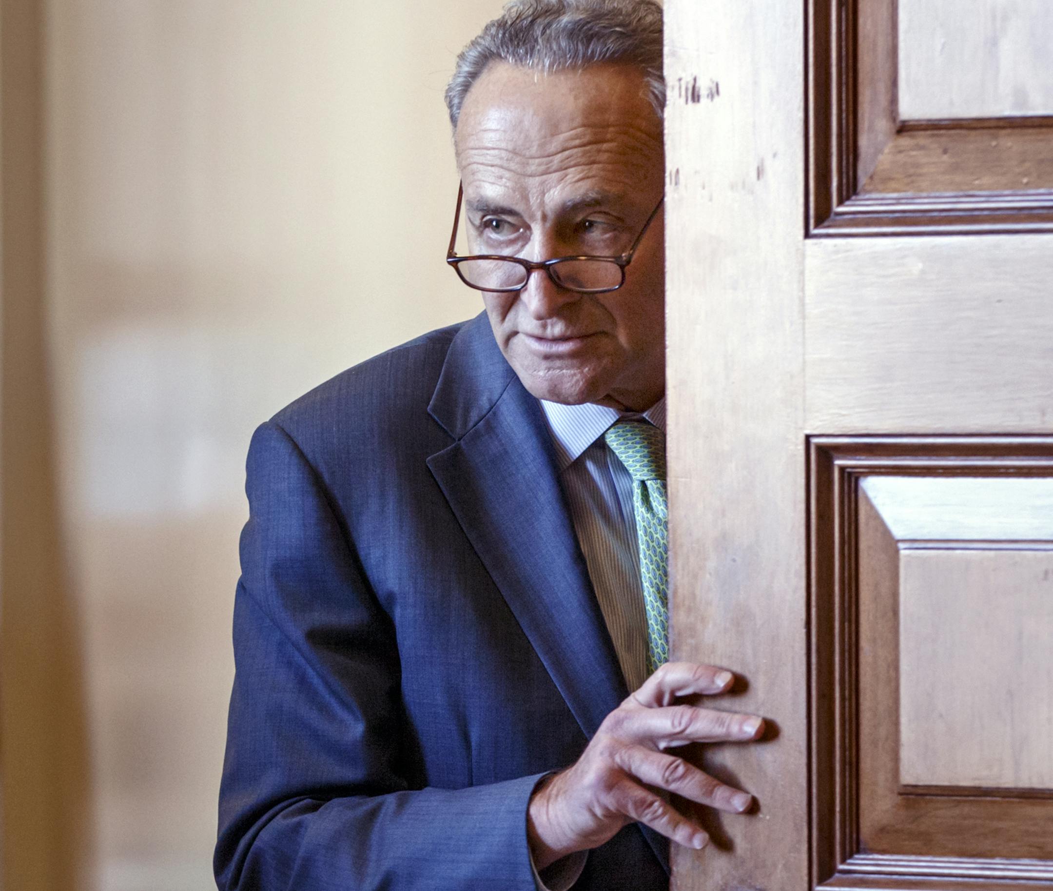 FILE - In this Nov. 18, 2014 file photo, Sen. Charles Schumer, D-N.Y., emerges from Democratic caucus before the Keystone XL pipeline vote at the Capitol in Washington. In a speech at the National Press Club today in Washington, Tuesday, Nov. 25, 2014, the Senate's third-ranking Democrat said that Democrats performed poorly in this month's midterm elections in part because they let Republicans portray government as a drag on society rather than a potential force for good. Schumer said Democrats'