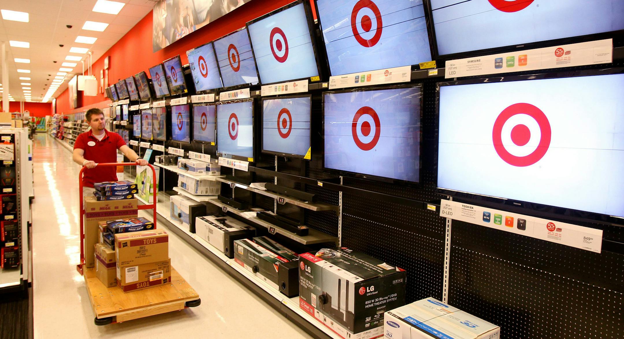 Brian Beeksma pushes a cart of goods as employees work on preparing the new Target store in Guelph, Ontario. Target announced that it is opening three pilot stores in Guelph, Fergus and Milton, Ontario March 5, 2013, the first of 124 Target stores to open in Canada, Media were given a preview tour, Monday, March 4, 2013. (AP Photo/The Canadian Press, Dave Chidley) ORG XMIT: CPOTK