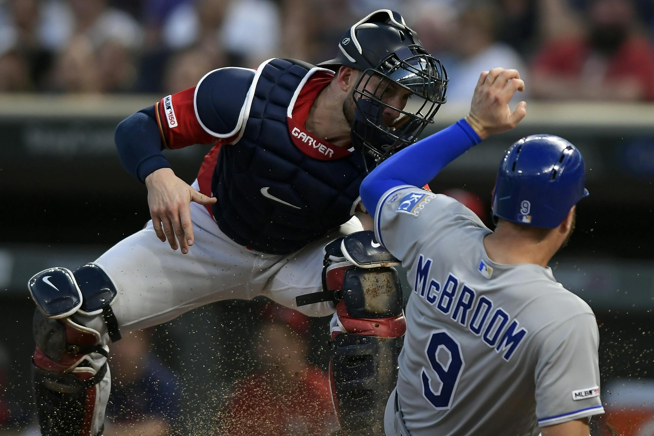 Kansas City Royals first baseman Ryan McBroom (9) was tagged out at home by Minnesota Twins catcher Mitch Garver (18) after a single hit by Royals catcher Meibrys Viloria (72) in the top of the second inning.
