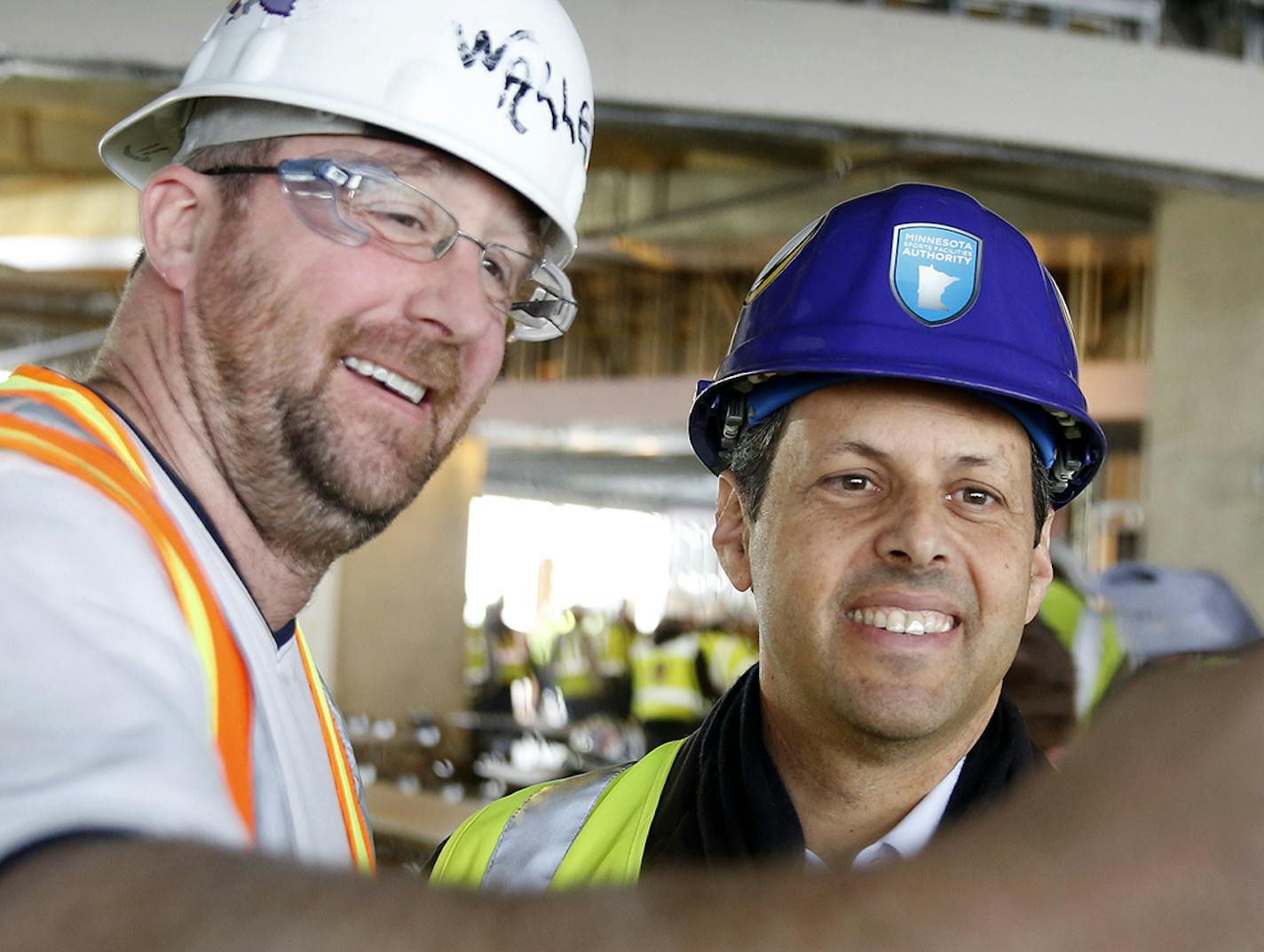 Vikings owner Mark Wilf takes a selfie with carpenter Chad Canesi during a free lunch provided to construction workers at Vikings Stadium on Friday, December 12, 2014. ] LEILA NAVIDI leila.navidi@startribune.com /