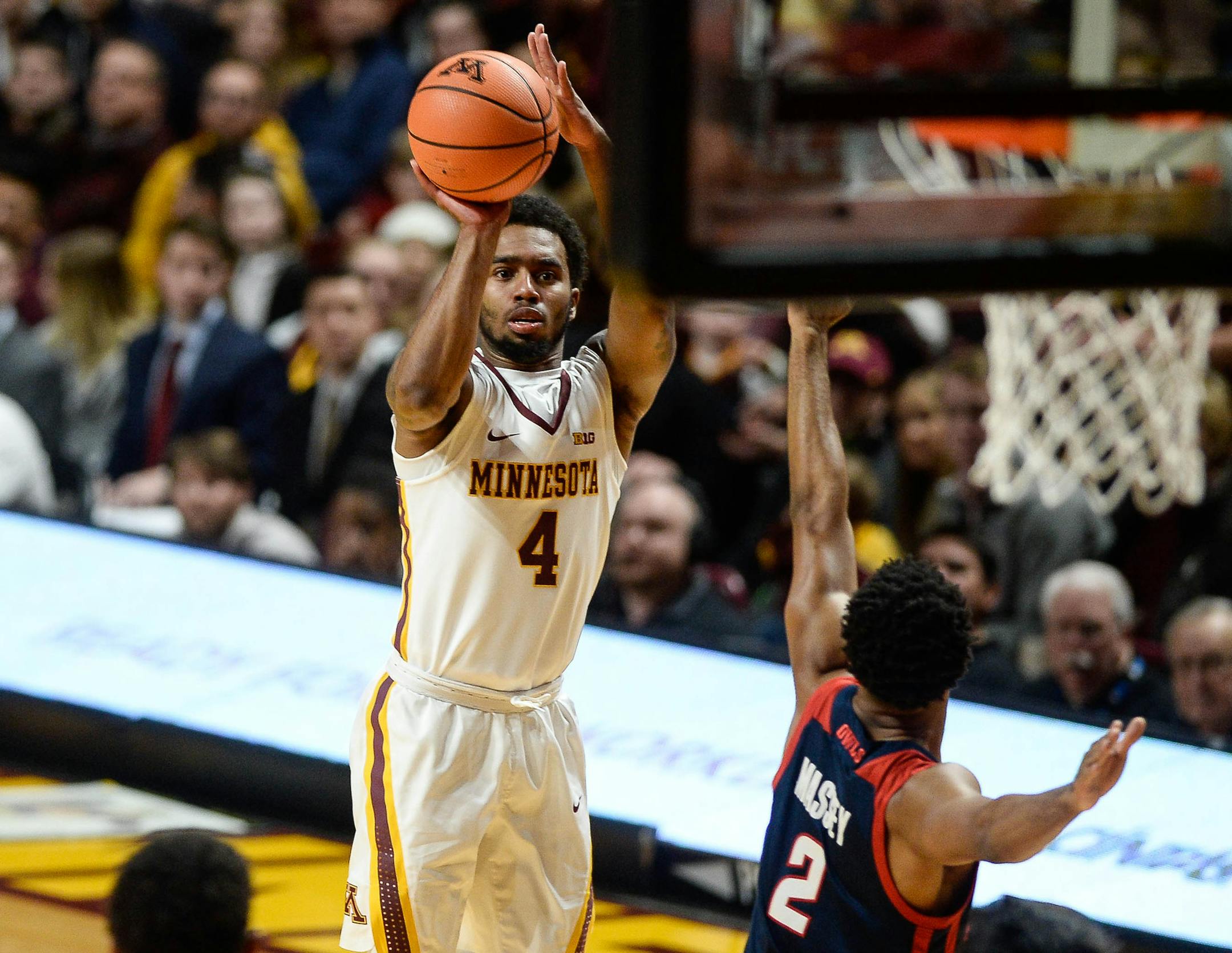 Minnesota Golden Gophers guard Jamir Harris (4) hit a 3-point basket in the first half as Florida Atlantic Owls guard Justin Massey (2) attempted to block. ] AARON LAVINSKY &#xef; aaron.lavinsky@startribune.com The University of Minnesota Golden Gophers men's basketball team played the Florida Atlantic University Owls on Saturday, Dec. 23, 2017 at Williams Arena in Minneapolis, Minn.
