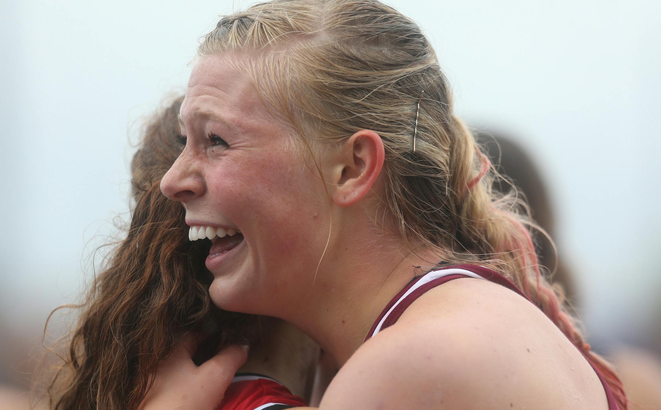 Lakeville South's Shaina Burns celebrated with a fellow hurdler after winning in the 100 meter hurdles. ] (KYNDELL HARKNESS/STAR TRIBUNE) kyndell.harkness@startribune.com During the Class 2A state track and field meet at Hamilne University in St Paul, Min. Saturday, June 7, 2014.