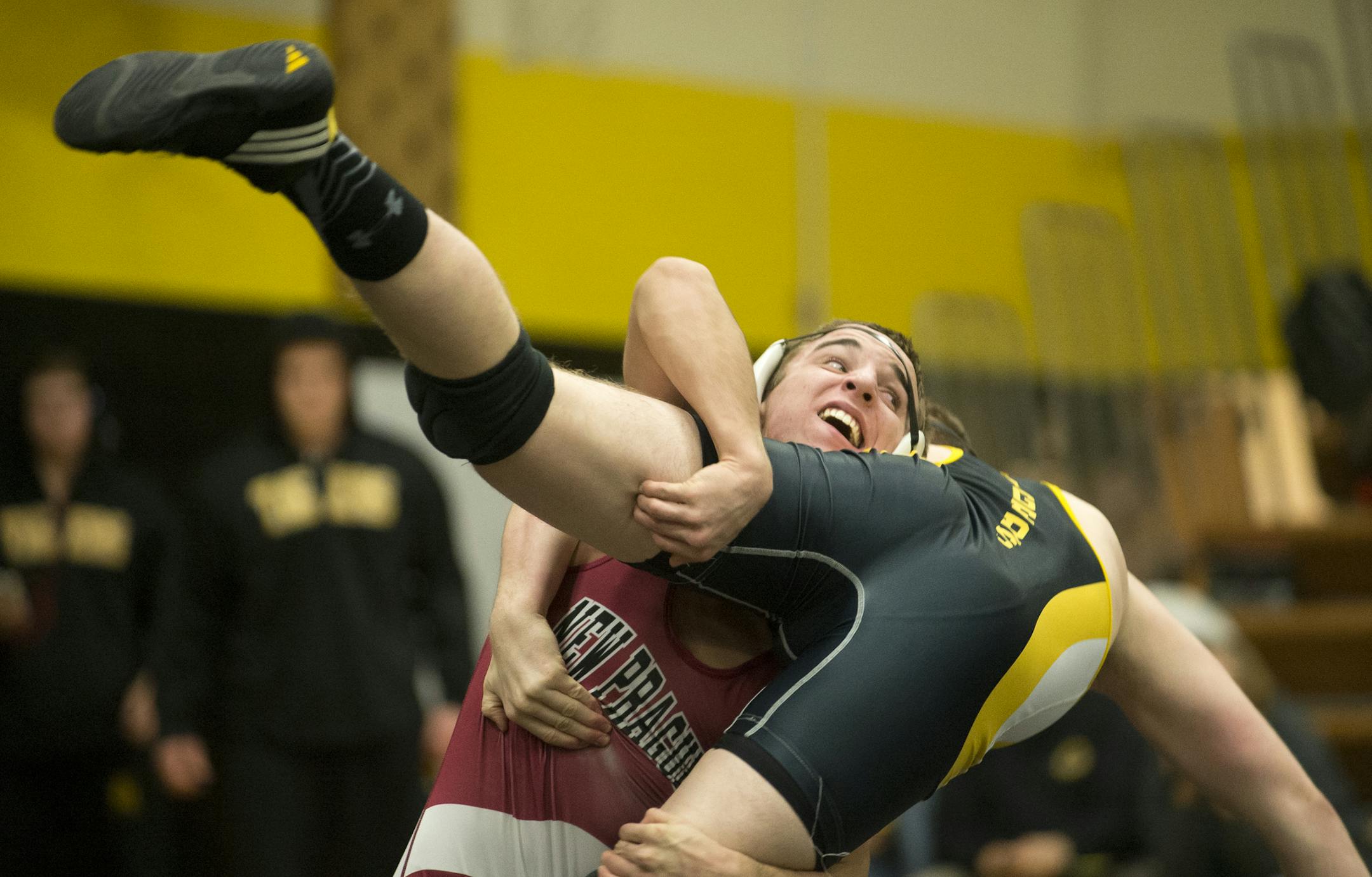 New Prague junior Nick Knutson takes down Hutchinson sophomore Tyler Stenzel during the first period of their match at Hutchinson High School Friday night. ] (Aaron Lavinsky | StarTribune) New Prague wrestling takes on Hutchinson at Hutchinson High School on Friday, Jan. 9, 2015.