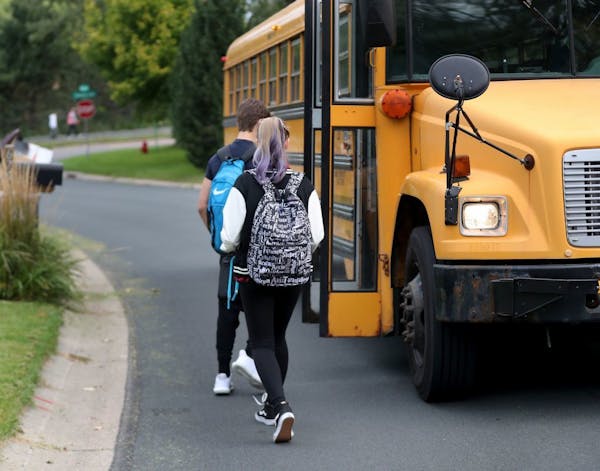 Students walk to board a school bus nicknamed "the secret bus," since these kids are basically doing reversed bussing, where they are leaving their sc