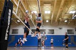 Pengsu Thao spiked the ball against Hmong Prep Academy players late in the third and final set of Wednesday night's match.