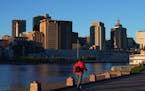 A man walked along the Mississippi River at Harriet Island Park as the setting sun illuminated the St. Paul skyline. ] ANTHONY SOUFFLE &#x2022; anthon