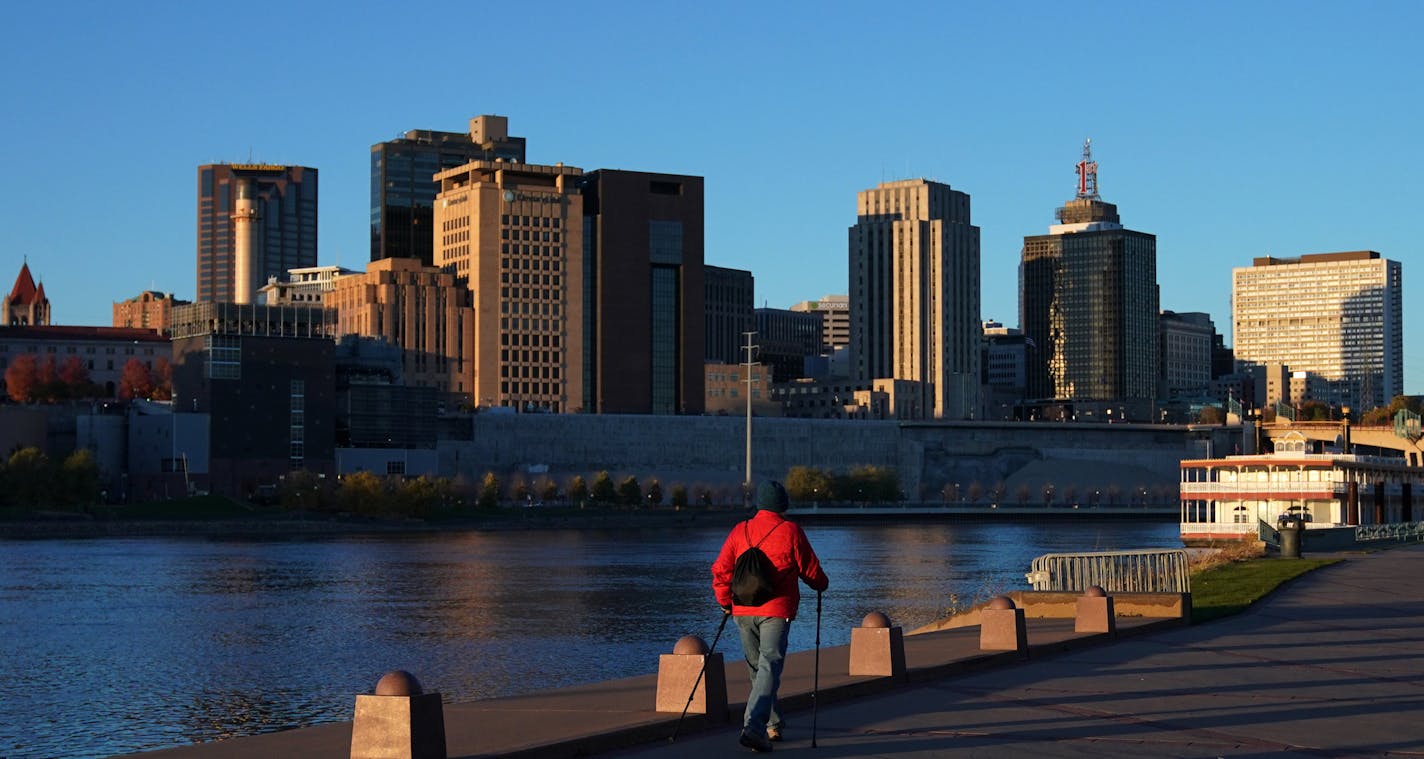 A man walked along the Mississippi River at Harriet Island Park as the setting sun illuminated the St. Paul skyline. ] ANTHONY SOUFFLE &#x2022; anthony.souffle@startribune.com The setting sun illuminated the city skyline Saturday, Oct. 20, 2018 at Harriet Island in St. Paul, Minn. Park More than 160 years after St. Paul cropped up along the Mississippi River, city officials want to reconnect the capital city with the riverfront. Part of that work involves rethinking the center of downtown -- the