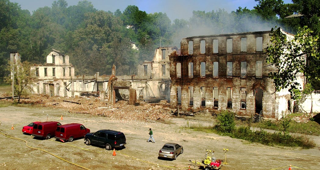 Smoke rises from the burned out shell of the prison in 2002, following the fire that occurred the night before.
