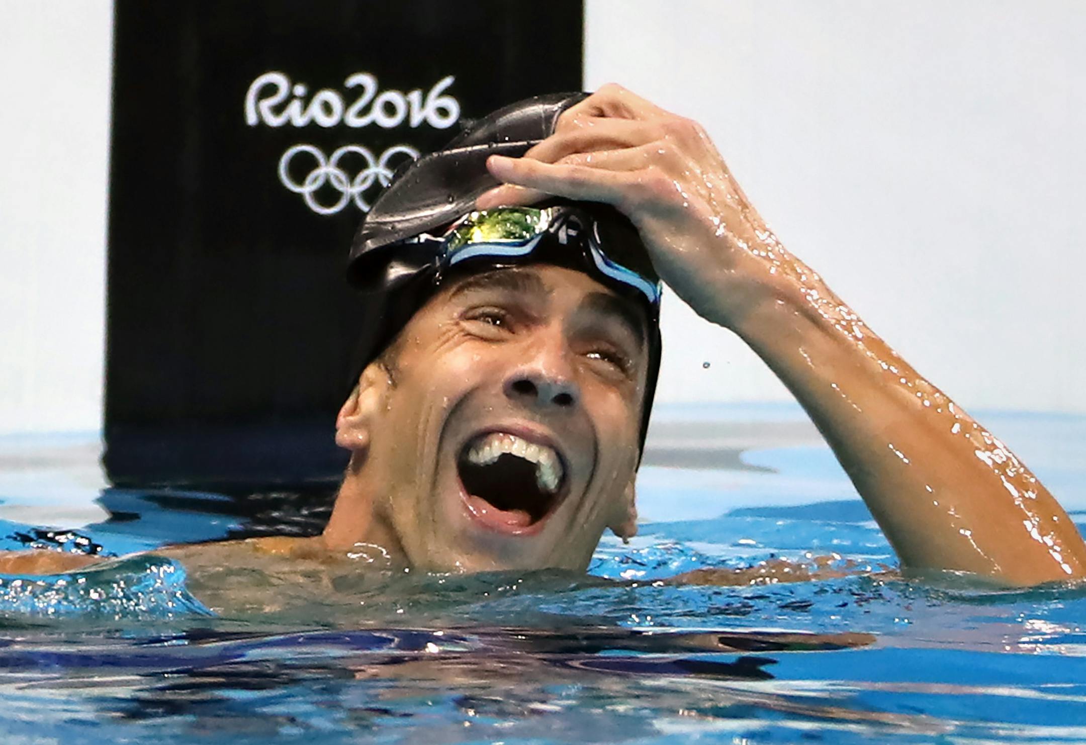 Michael Phelps reacts to winning a three way tie for silver in the 100 meter butterfly.
