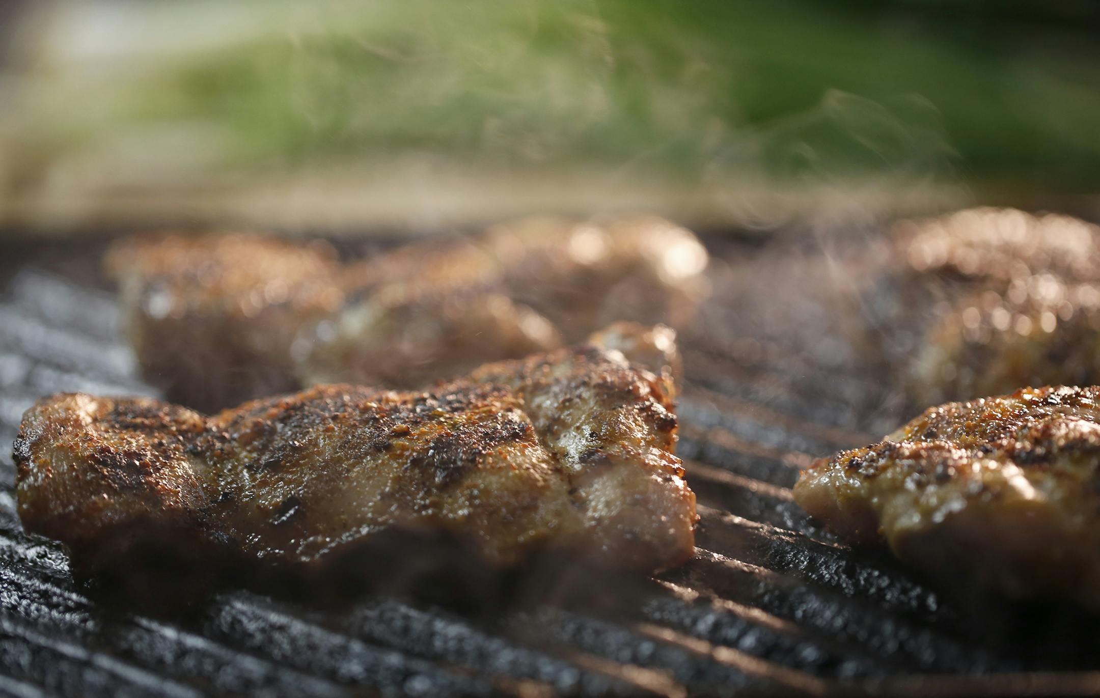 Shichimi togarashi, a Japanese chili pepper spice blend, is sprinkled on chicken thighs before grilling. (Michael Tercha/Chicago Tribune/TNS) ORG XMIT: 1185932