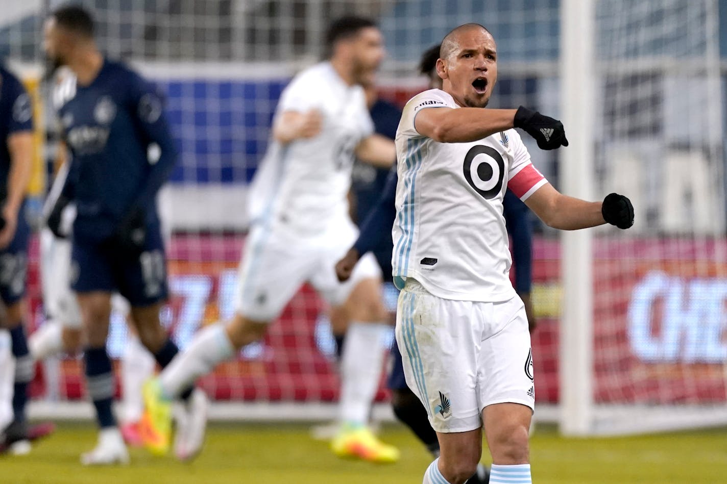 Minnesota United midfielder Osvaldo Alonso celebrates after a goal by Bakaye Dibassy during the first half of the team's MLS match against Sporting Kansas City on Thursday