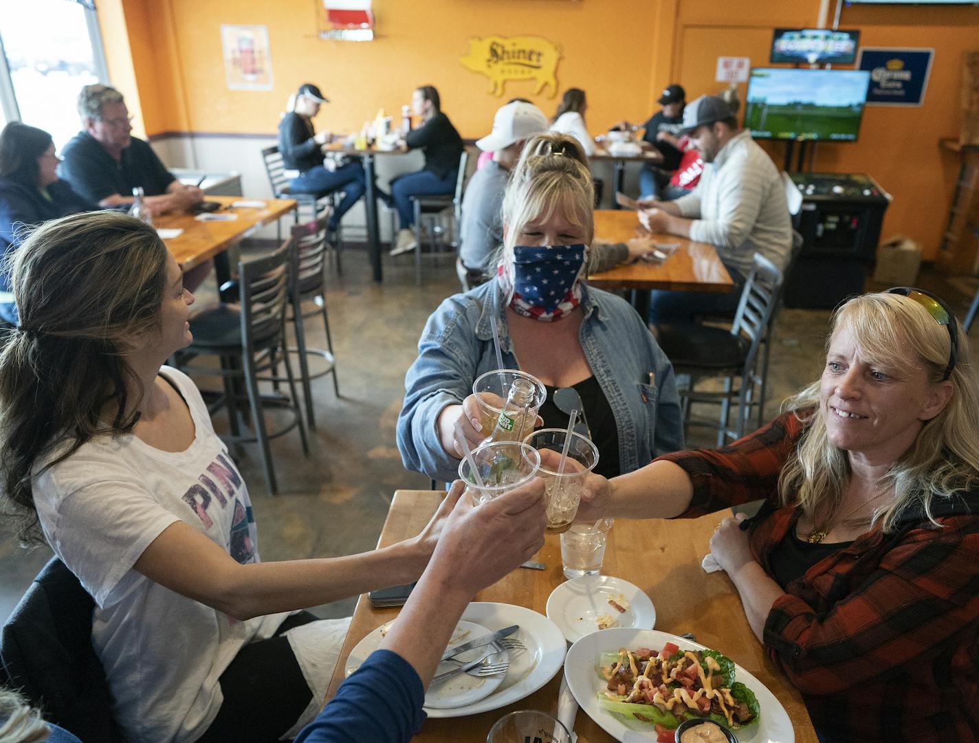 Friends Carrie Nasi left ,Tracey (did not give her last name), Cindy Colema and Lori Stayberg , met for food and drinks at Jonesy's Local Bar on the first day of the bar reopening in Hudson .] Jerry Holt •Jerry.Holt@startribune.com Bars, restaurants and everything else is reopening in Wisconsin after the state Supreme Court struck down the state's stay-at-home order Thursday May 14, 2020 in Hudson , Wisconsin.