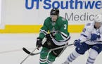 Dallas Stars' John Klingberg (3) of Sweden and Toronto Maple Leafs' Tyler Bozak (42) compete for control of the puck in the third period of an NHL hoc