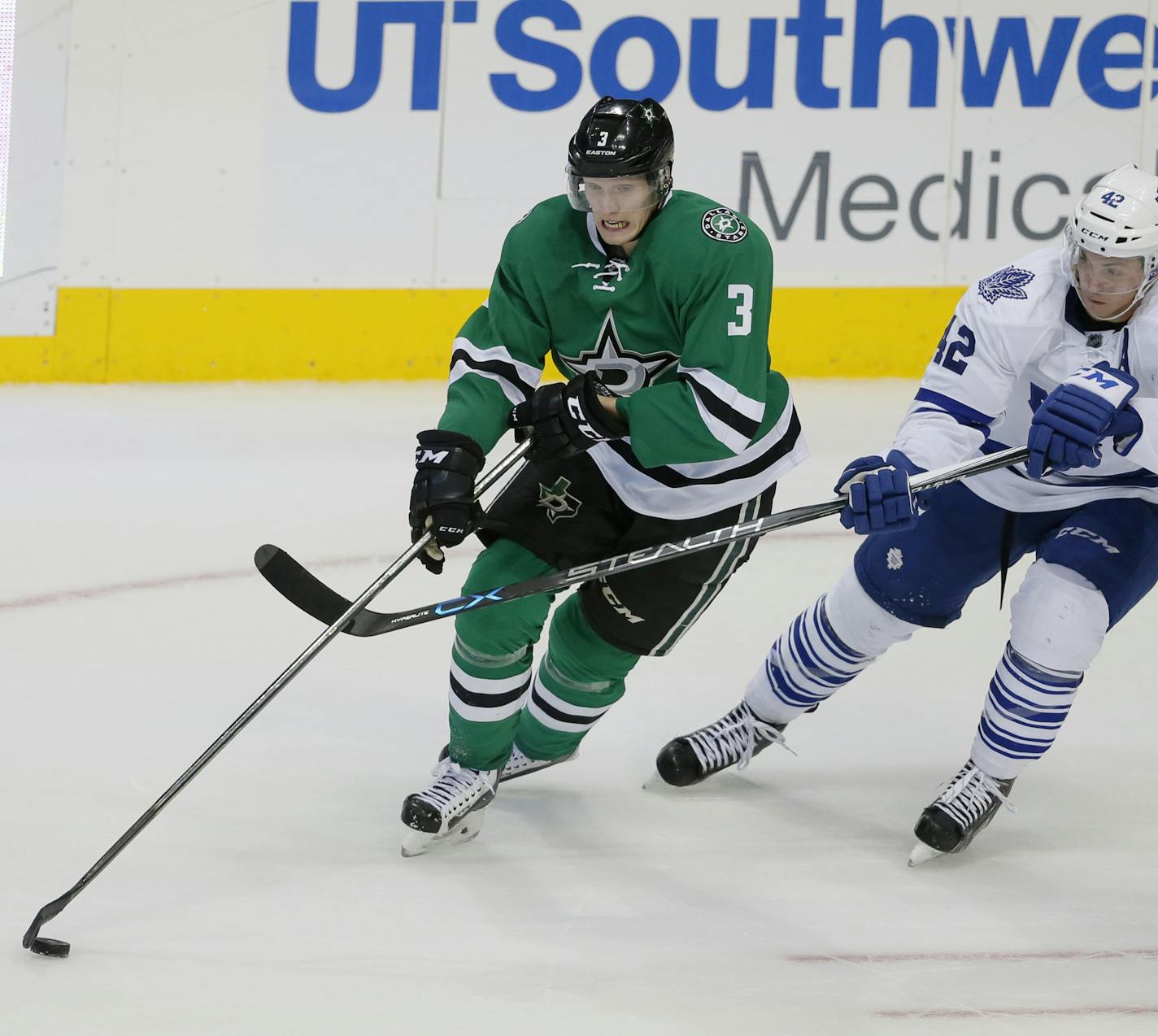 Dallas Stars' John Klingberg (3) of Sweden and Toronto Maple Leafs' Tyler Bozak (42) compete for control of the puck in the third period of an NHL hockey game Tuesday, Nov. 10, 2015, in Dallas. (AP Photo/Tony Gutierrez) ORG XMIT: MIN2015112716485346