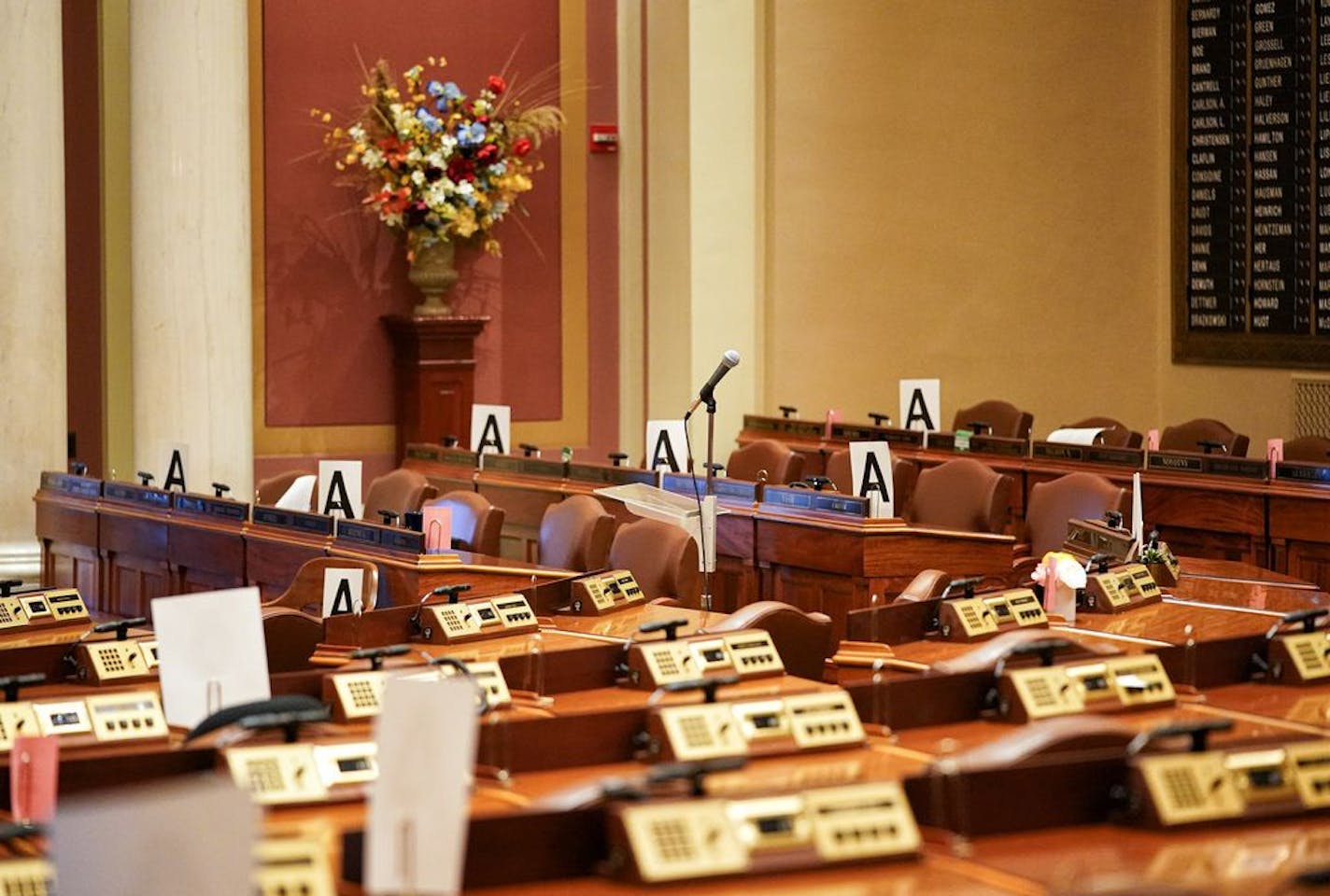 The House Chamber remained empty Wednesday, with every other desk marked with an "A" those may be occupied to maintain social distancing when they return.