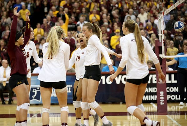 University of Minnesota celebrate their 3 sets to 0 victory over the University of North Dakota in the first round of the NCAA volleyball tournament a