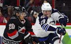 Winnipeg Jets' Patrik Laine (29) battles Carolina Hurricanes' Sebastian Aho (20) during the second period of an NHL hockey game, Sunday, Nov. 20, 2016