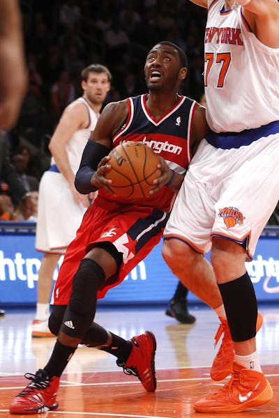 Washington Wizards' John Wall (2) drives against the New York Knicks during the second half of an NBA basketball game Monday, Dec. 16, 2013, in New Yo