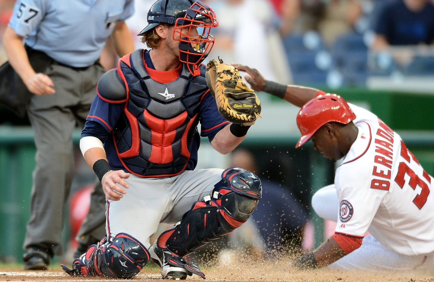 Washington Nationals left fielder Roger Bernadina (33) scores ahead of a tag by Minnesota Twins catcher Chris Herrmann (12) in the first inning of the second game of a day-night doubleheader at Nationals Park in Washington, D.C., Sunday, June 9, 2013.