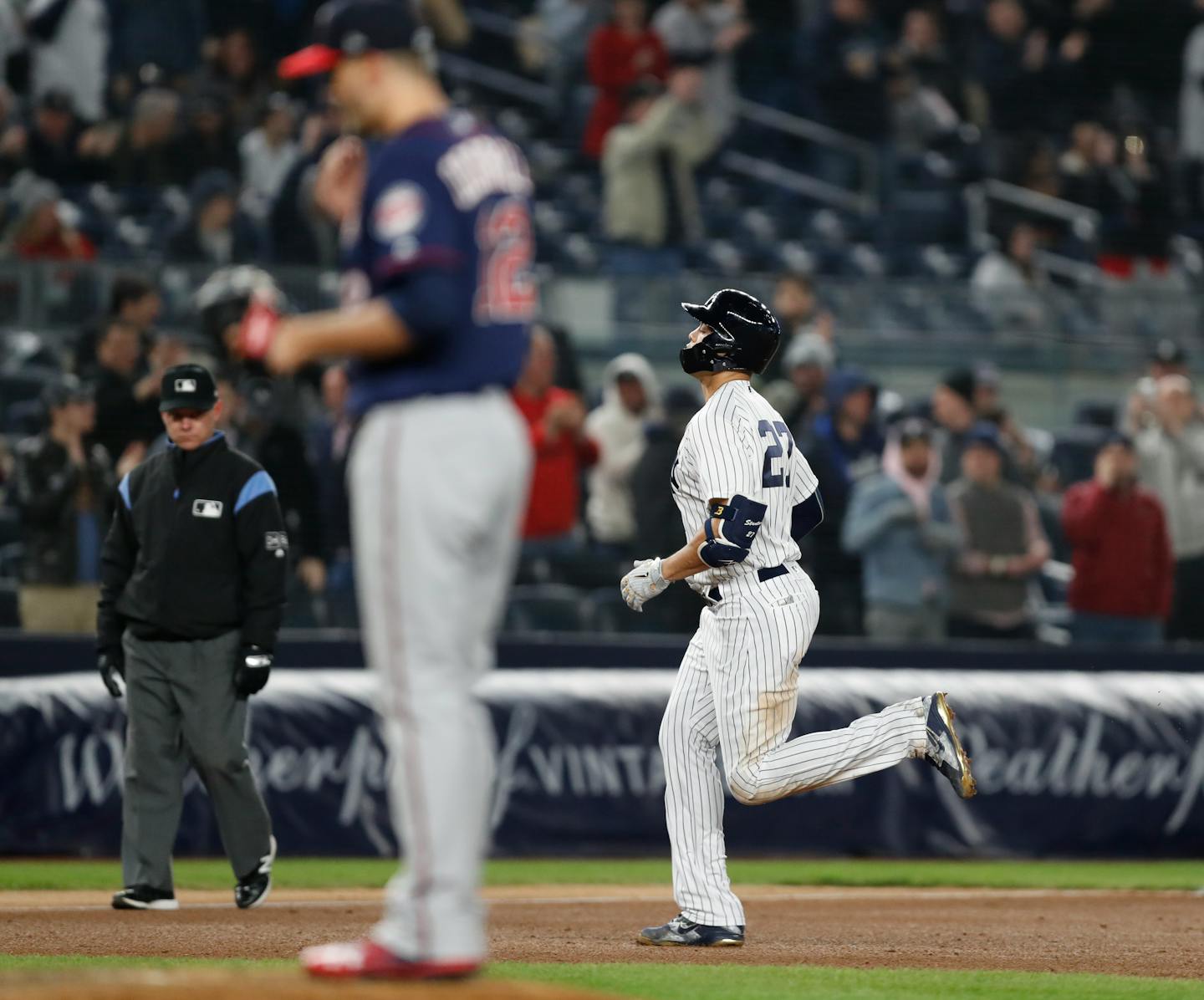 Yankees designated hitter Giancarlo Stanton, right, jogged around the bases past Twins starter Jake Odorizzi after hitting a solo home run during the fifth inning of New York's 14-1 drubbing of the Twins on Monday.