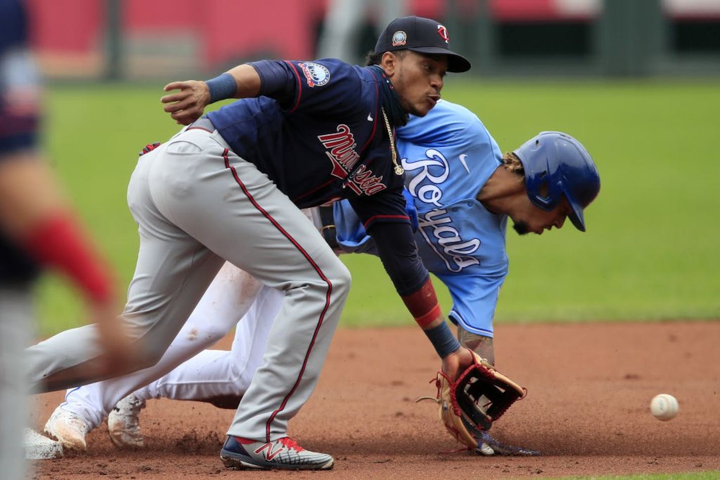 Kansas City Royals Adalberto Mondesi, back, steals second base behind Minnesota Twins shortstop Jorge Polanco during the first inning of a baseball game at Kauffman Stadium in Kansas City, Mo., Sunday, Aug. 9, 2020.