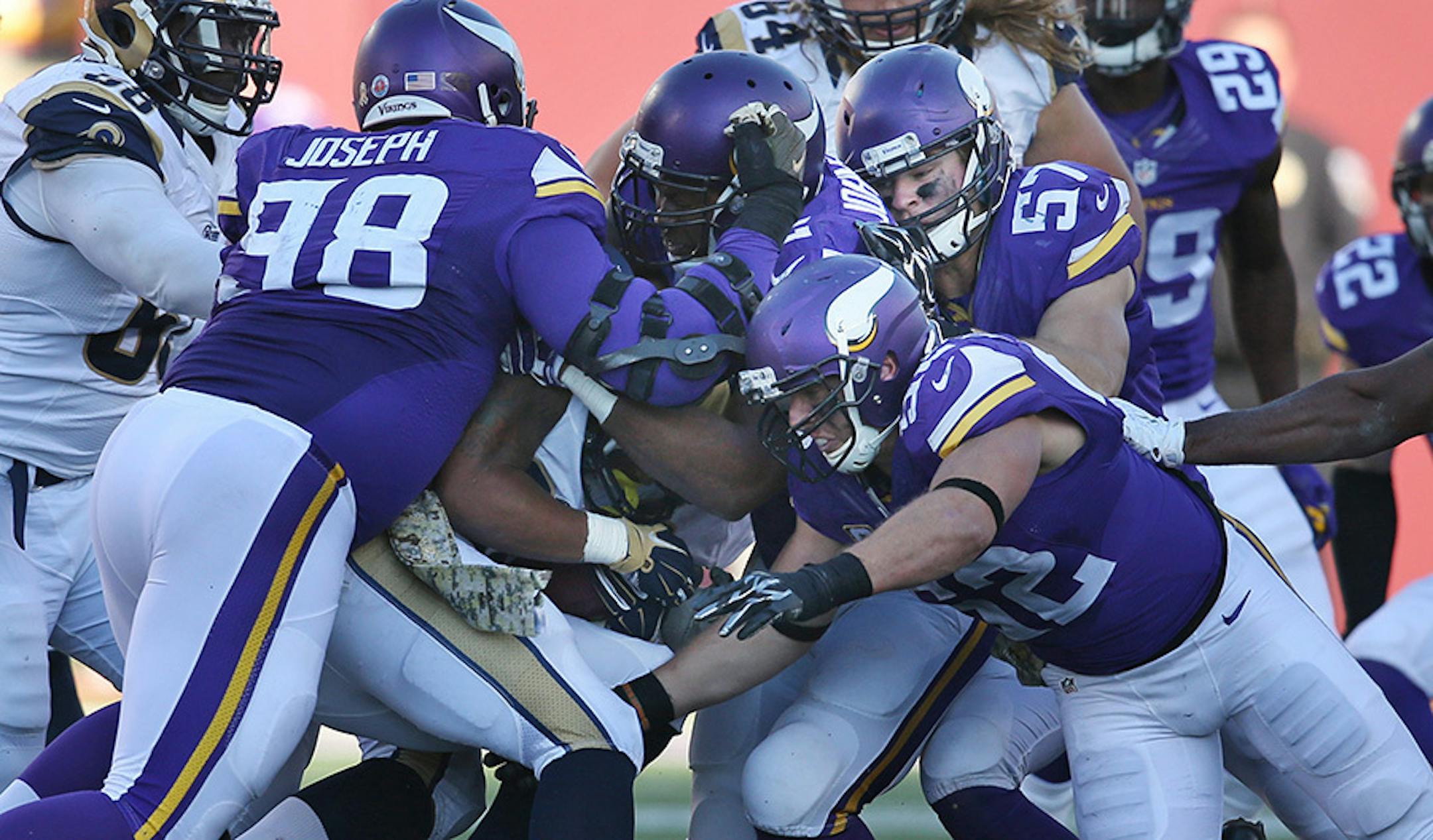 Minnesota Vikings defensive tackle Linval Joseph (98) ,Tom Johnson (92) and Chad Greenway stopped St. Louis Rams running back Todd Gurley (30) in third quarter Sunday November 8, 2015 in Minneapolis, MN.