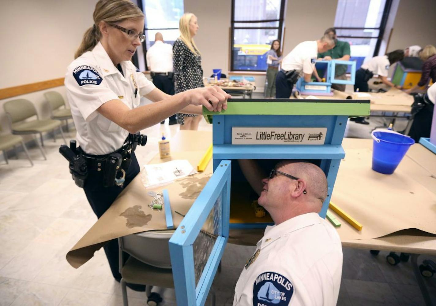 Minneapolis police inspectors Kathy Waite and Mike Sullivan assembled a little free library at Minneapolis City Hall in 2015. Waite, inspector of the Fifth Precinct, is one of two women in one of the department's top 20 posts.