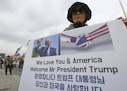 In this Wednesday, Nov. 1, 2017, photo, a South Korean protester against North Korea stands to welcome a planned visit by the U.S. President U.S. Pres