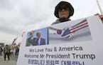 In this Wednesday, Nov. 1, 2017, photo, a South Korean protester against North Korea stands to welcome a planned visit by the U.S. President U.S. Pres