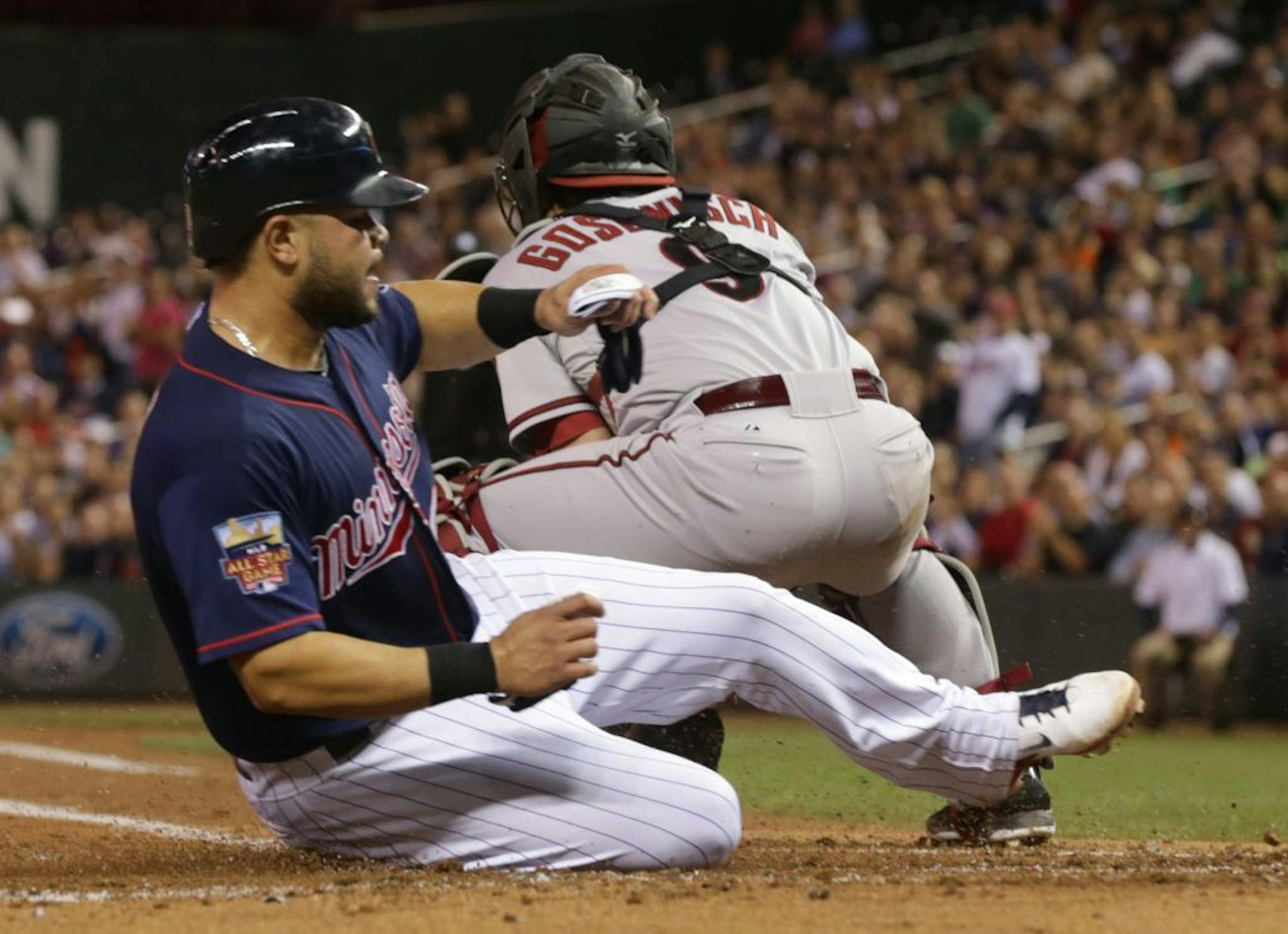 The Twins' Josmil Pinto, right, scored past Diamondbacks catcher Tuffy Gosewisch on a single by Eduardo Escobar in the second inning Tuesday.